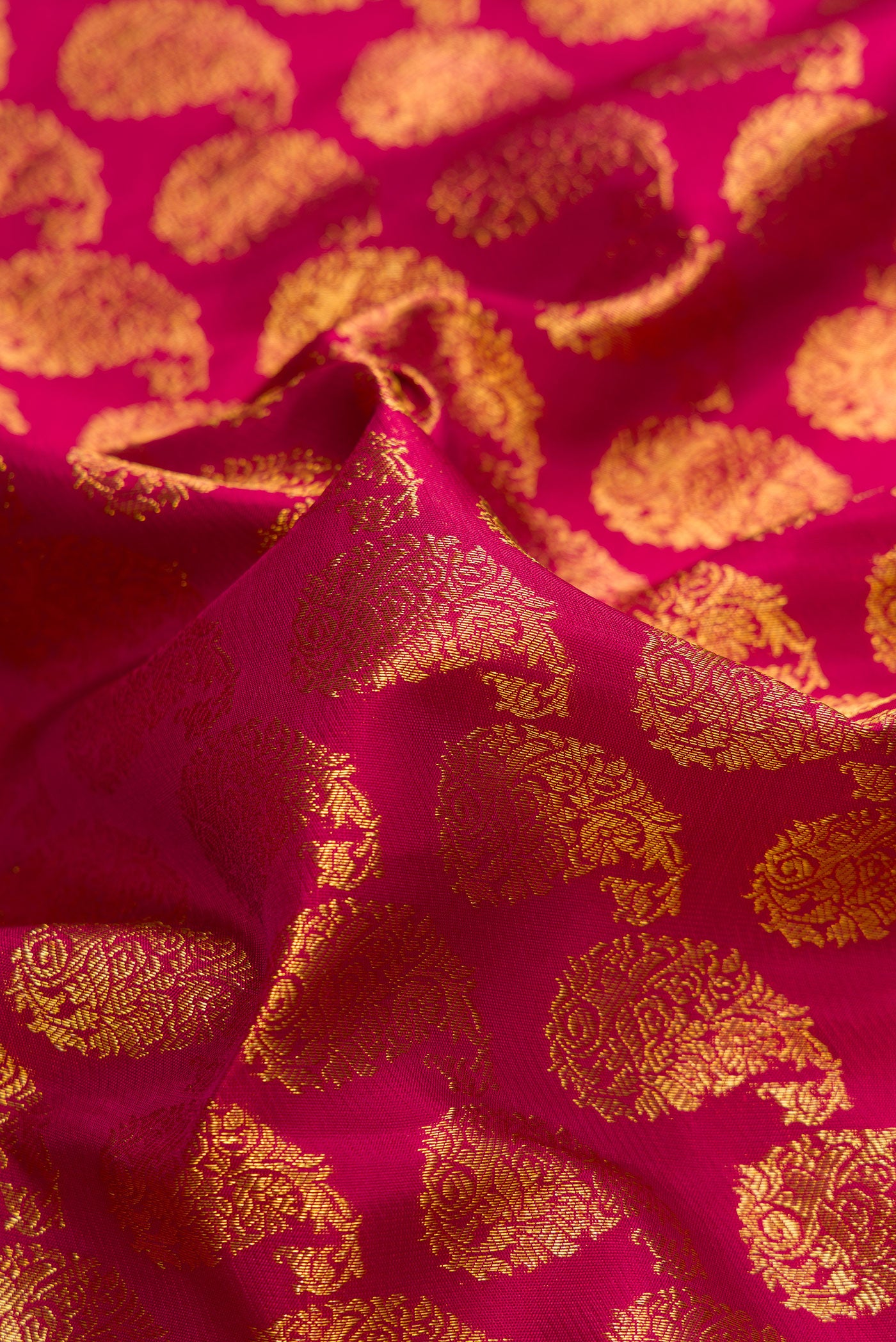 Close up of Maroon Dual Tone Kanjivaram Silk Saree with Zari Brocade on the body and Zari Border.  displaying folds