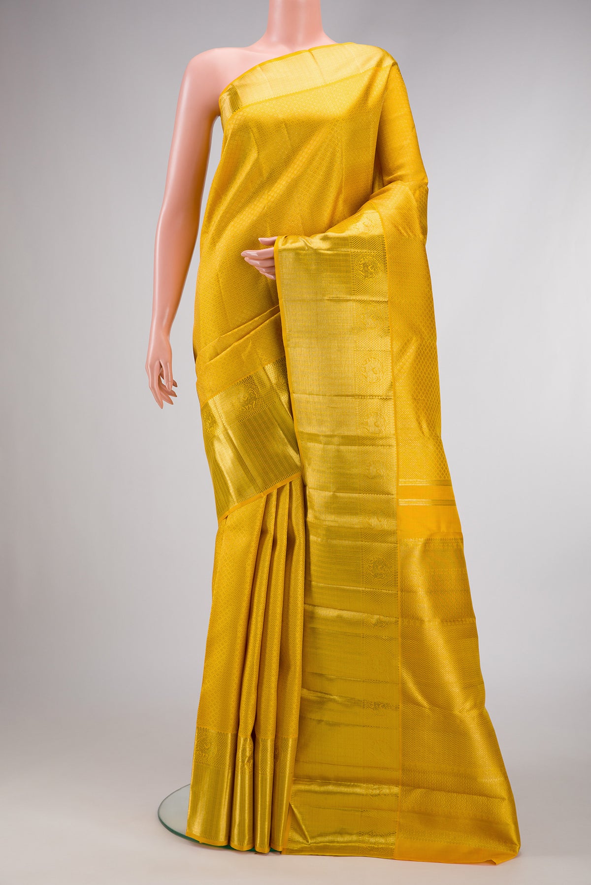 Yellow Dual Tone Kanjivaram Silk Saree with Zari Brocade on the body and Zari Border.  displayed on a mannequin