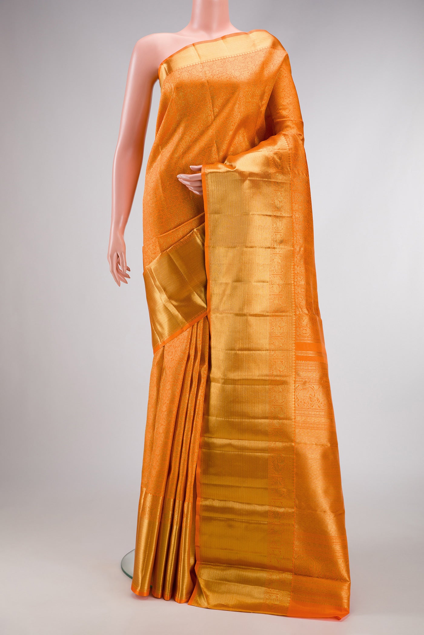 Orange Dual Tone Kanjivaram Silk Saree with Zari Brocade on the body and Zari Border.  displayed on a mannequin