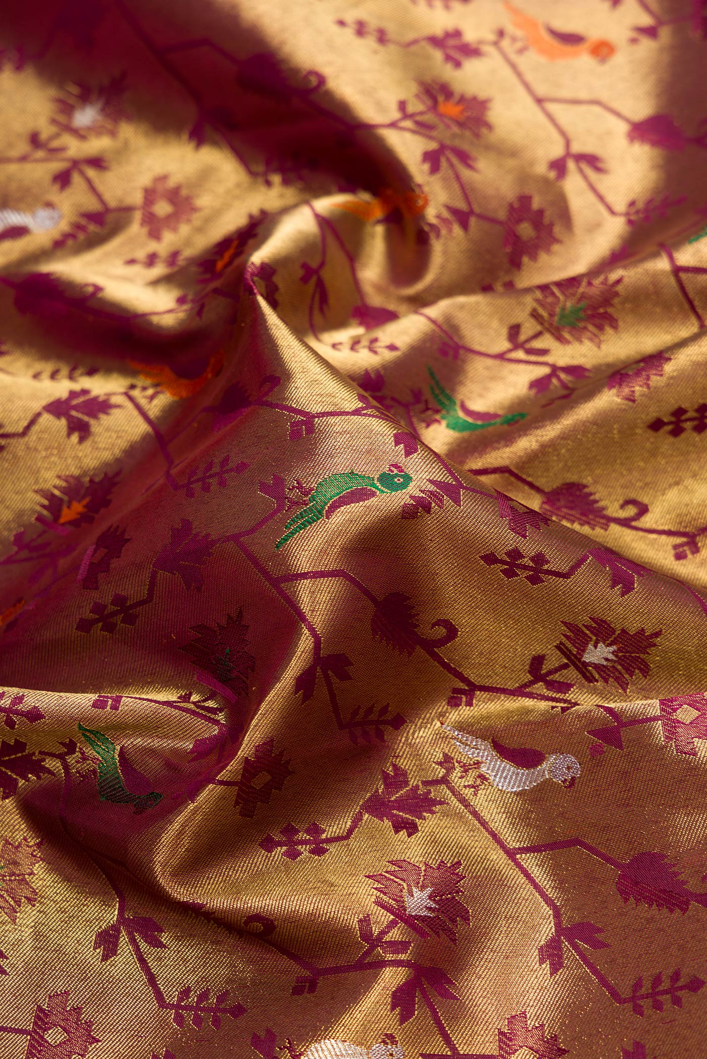 Close up of Pure Silk Pure Zari Burgundy Dual Tone Kanjivaram Saree with Zari Brocade on the body and Zari Border.  displaying folds