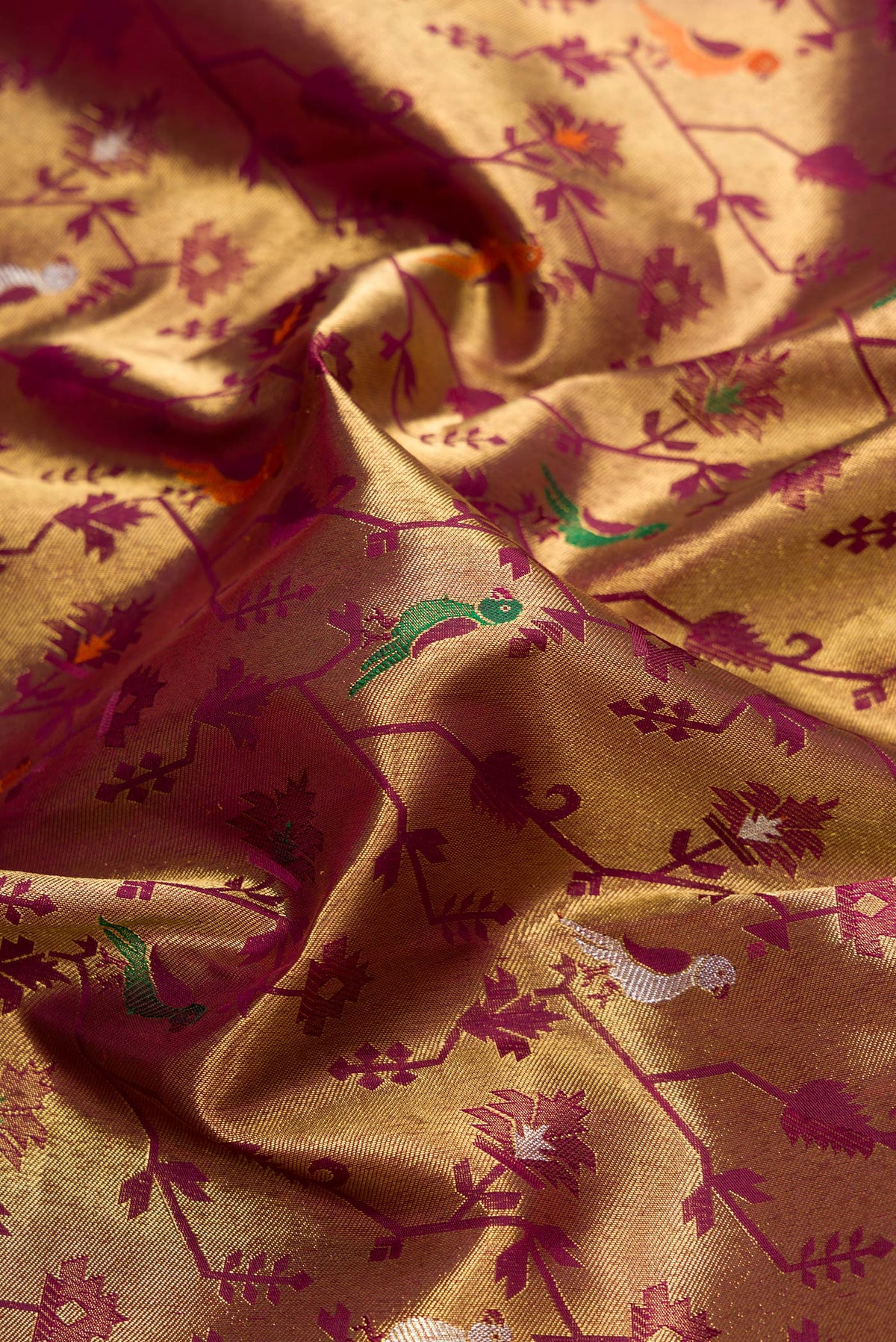 Close up of Pure Silk Pure Zari Burgundy Dual Tone Kanjivaram Saree with Zari Brocade on the body and Zari Border.  displaying folds