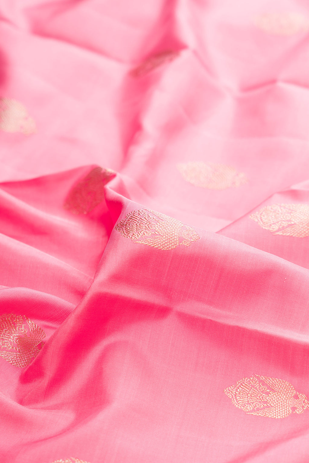 Close up of Pure Silk Pure Zari Pink Kanjivaram Saree with Zari Butta on the body and Fancy Border.  displaying folds