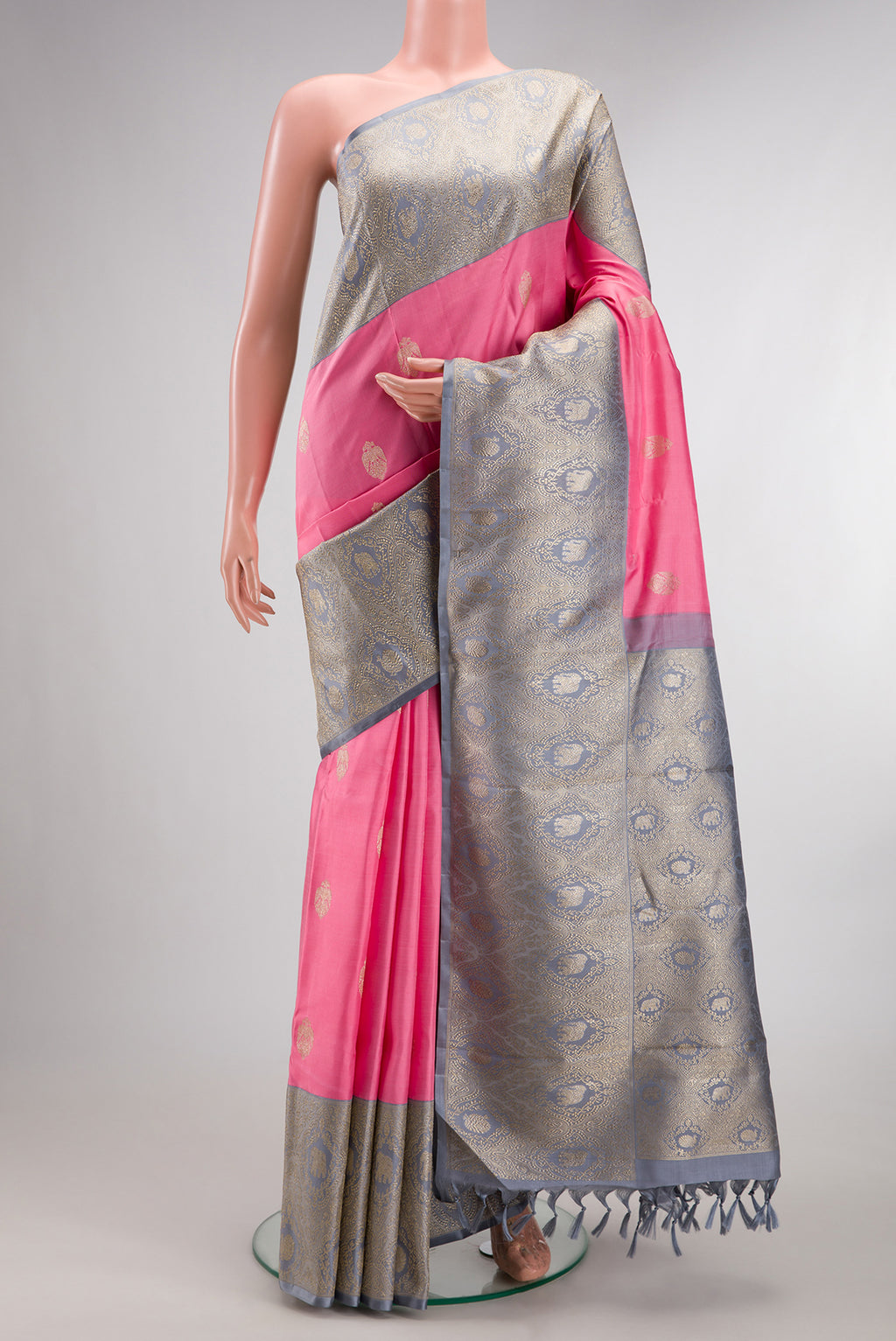 Pure Silk Pure Zari Pink Kanjivaram Saree with Zari Butta on the body and Fancy Border.  displayed on a mannequin