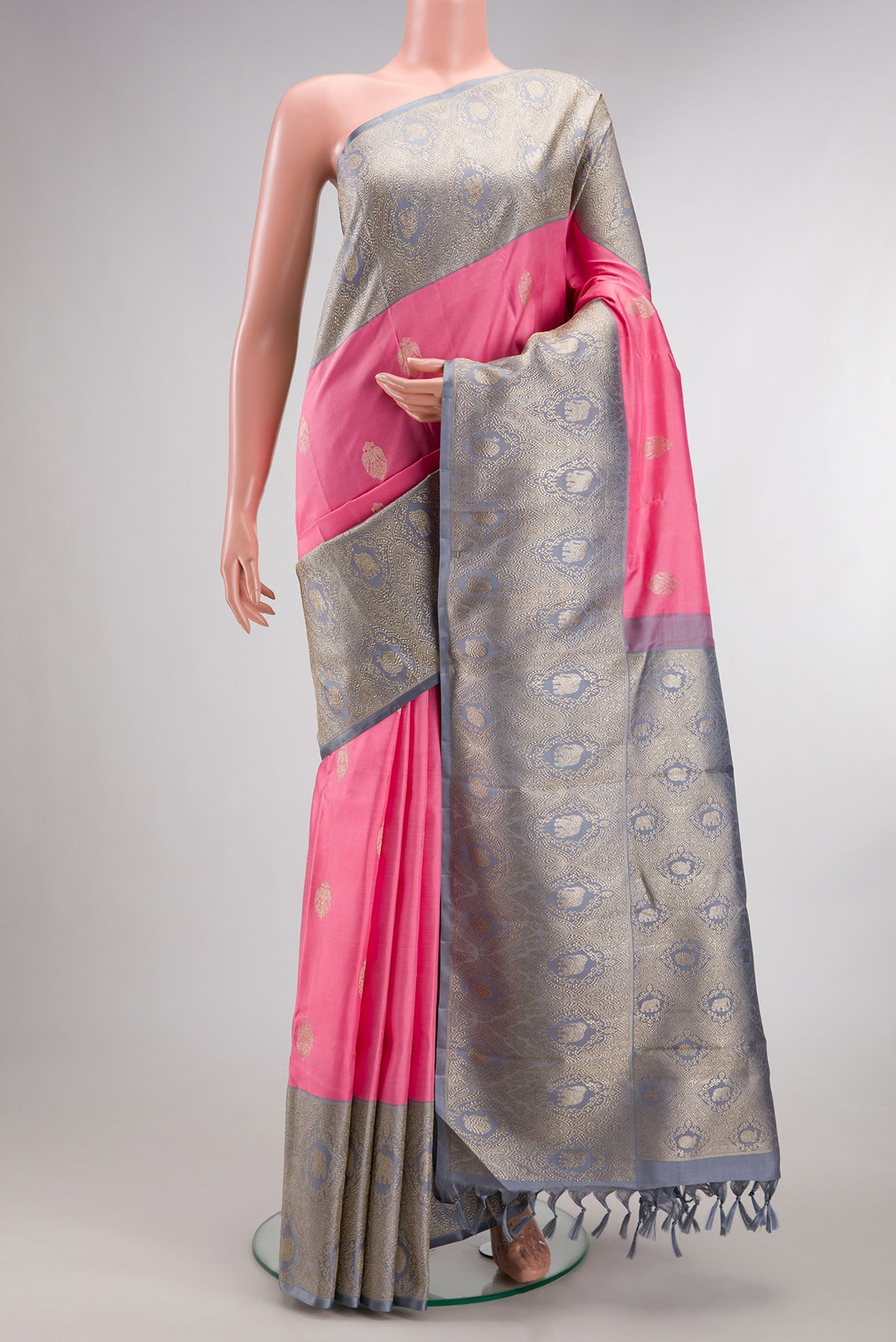 Pure Silk Pure Zari Pink Kanjivaram Saree with Zari Butta on the body and Fancy Border.  displayed on a mannequin