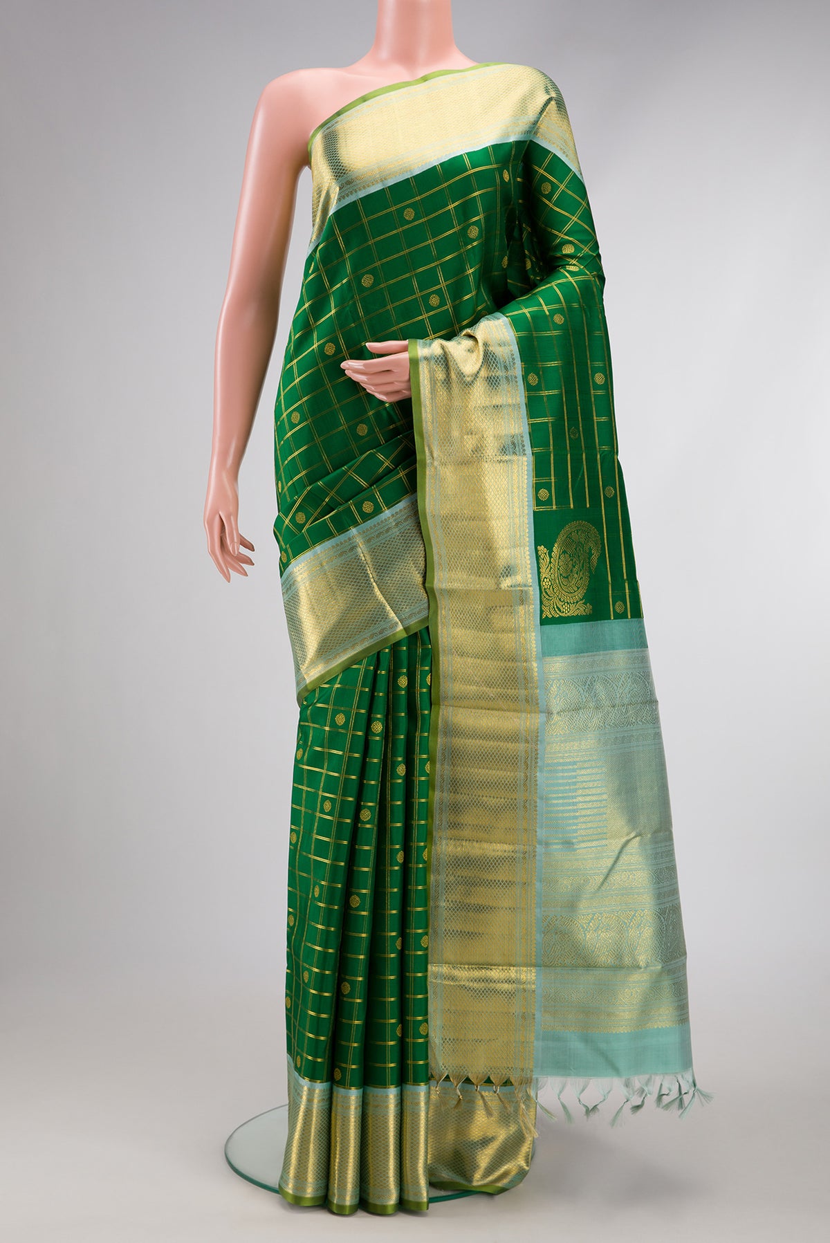 Pure Silk Pure Zari Green Kanjivaram Saree with Checked design on the body and Zari Border.  displayed on a mannequin