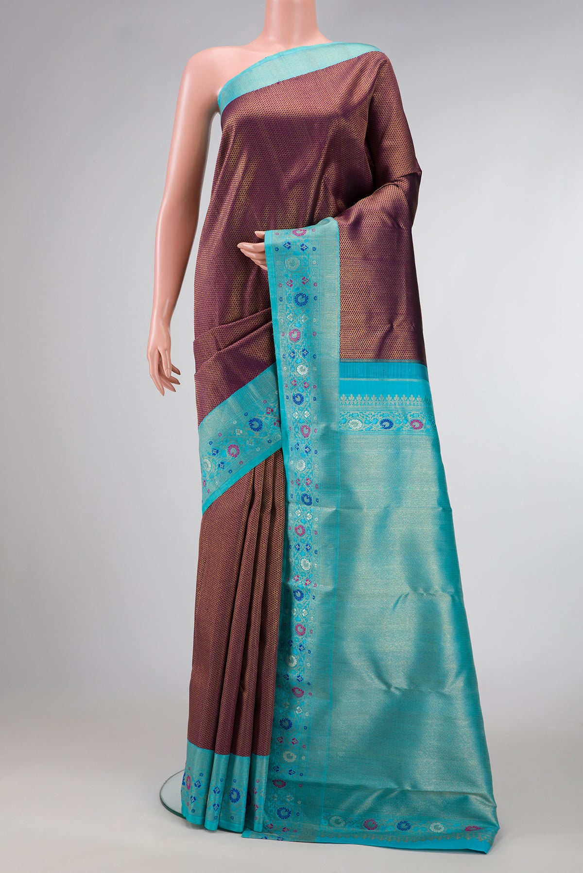 Burgundy Dual Tone Kanjivaram Silk Saree with Zari Brocade on the body and Fancy Border.  displayed on a mannequin