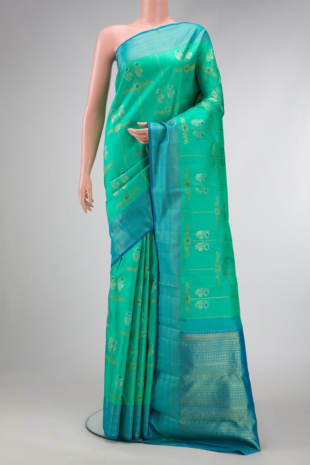 Pure Silk Pure Zari Sea Green Dual Tone Kanjivaram Saree with Zari Butta on the body and Zari Border.  displayed on a mannequin