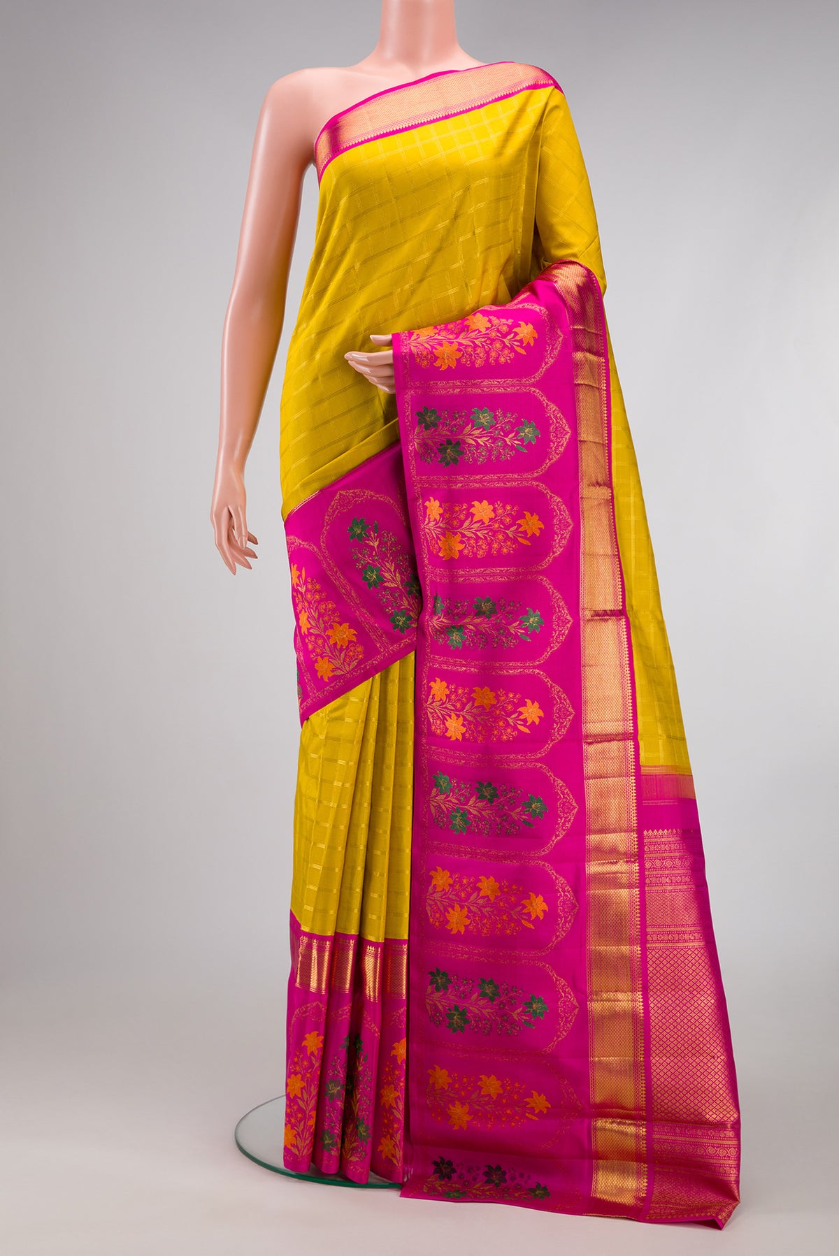 Yellow Kanjivaram Silk Saree with Checked design on the body and Fancy Border.  displayed on a mannequin