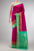 Pure Silk Pure Zari Magenta Dual Tone Kanchipuram Saree with Zari Butta on the body and Fancy Border.  displayed on a mannequin