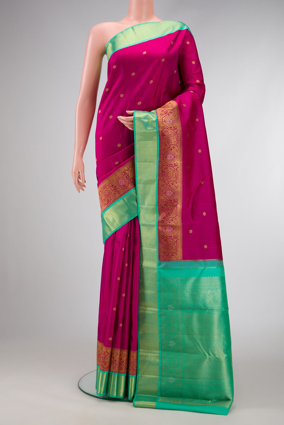 Pure Silk Pure Zari Magenta Dual Tone Kanchipuram Saree with Zari Butta on the body and Fancy Border.  displayed on a mannequin