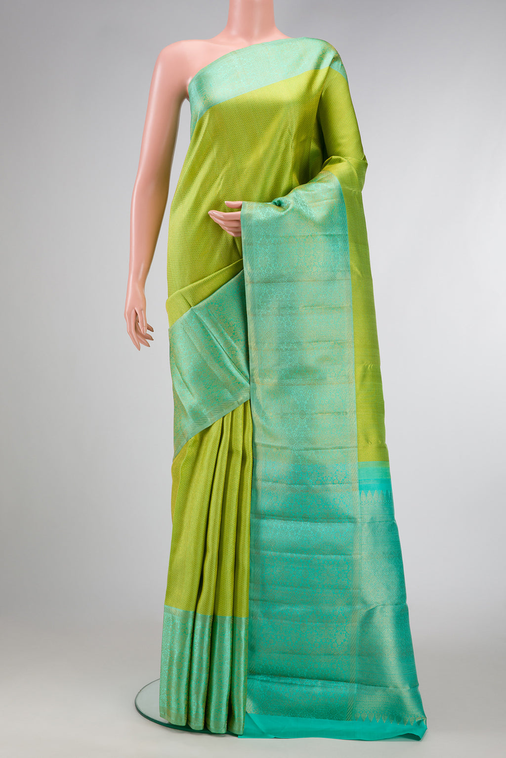 Parrot Green Dual Tone Kanchipuram Silk Saree with Zari Brocade on the body and Zari Border.  displayed on a mannequin