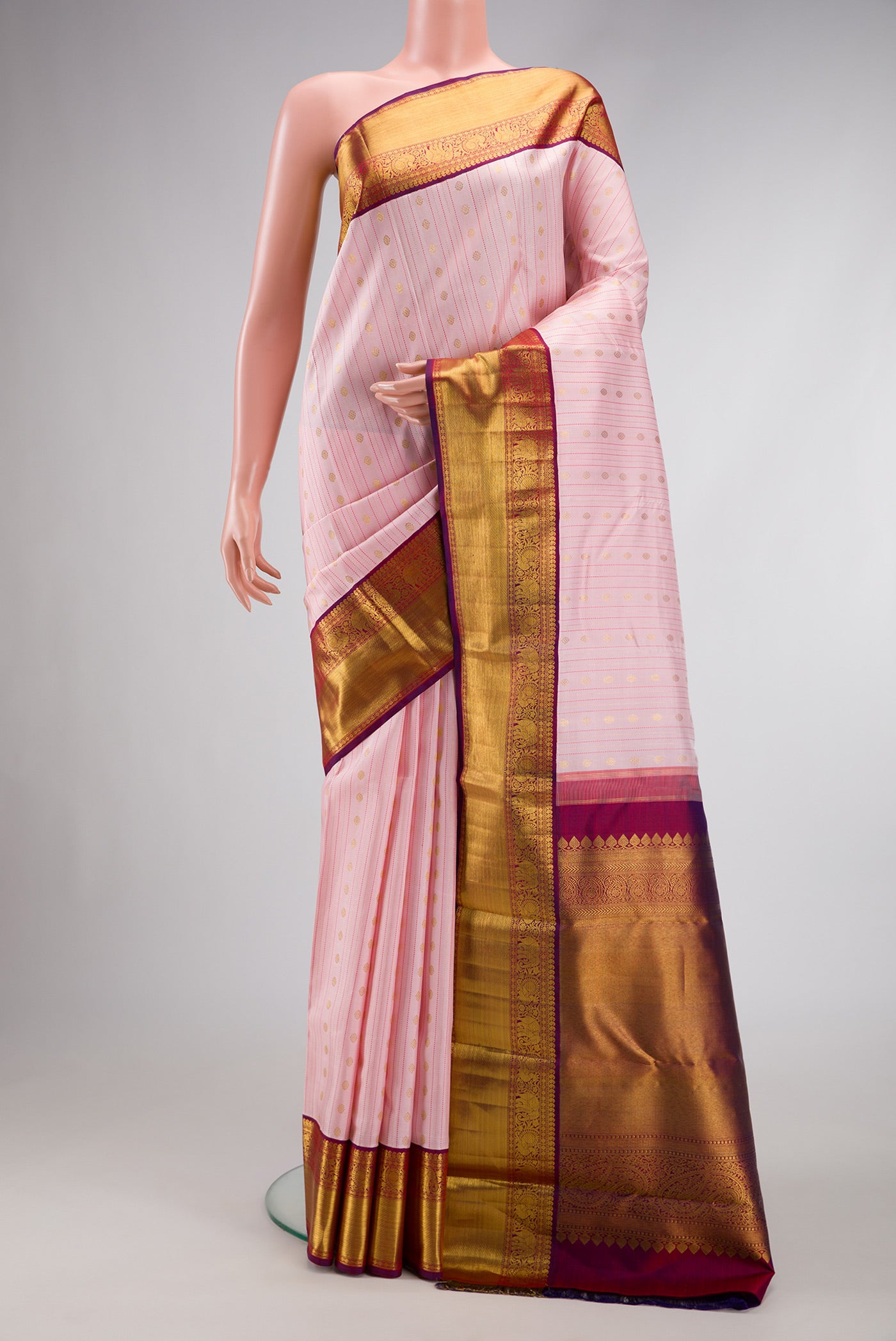 Pure Silk Pure Zari Pink Dual Tone Kanchipuram Saree with Stripes on the body and Zari Border.  displayed on a mannequin