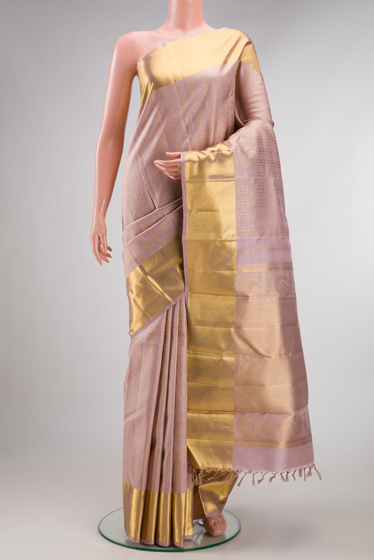 Pure Silk Rose Gold Kanchipuram Saree with Zari Brocade on the body and Zari Border.  displayed on a mannequin