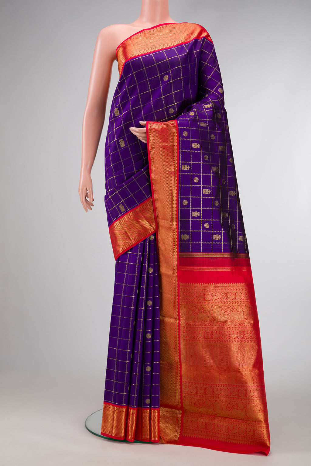 Pure Silk Pure Zari Violet Dual Tone Kanjivaram Saree with Checked design on the body and Zari Border.  displayed on a mannequin