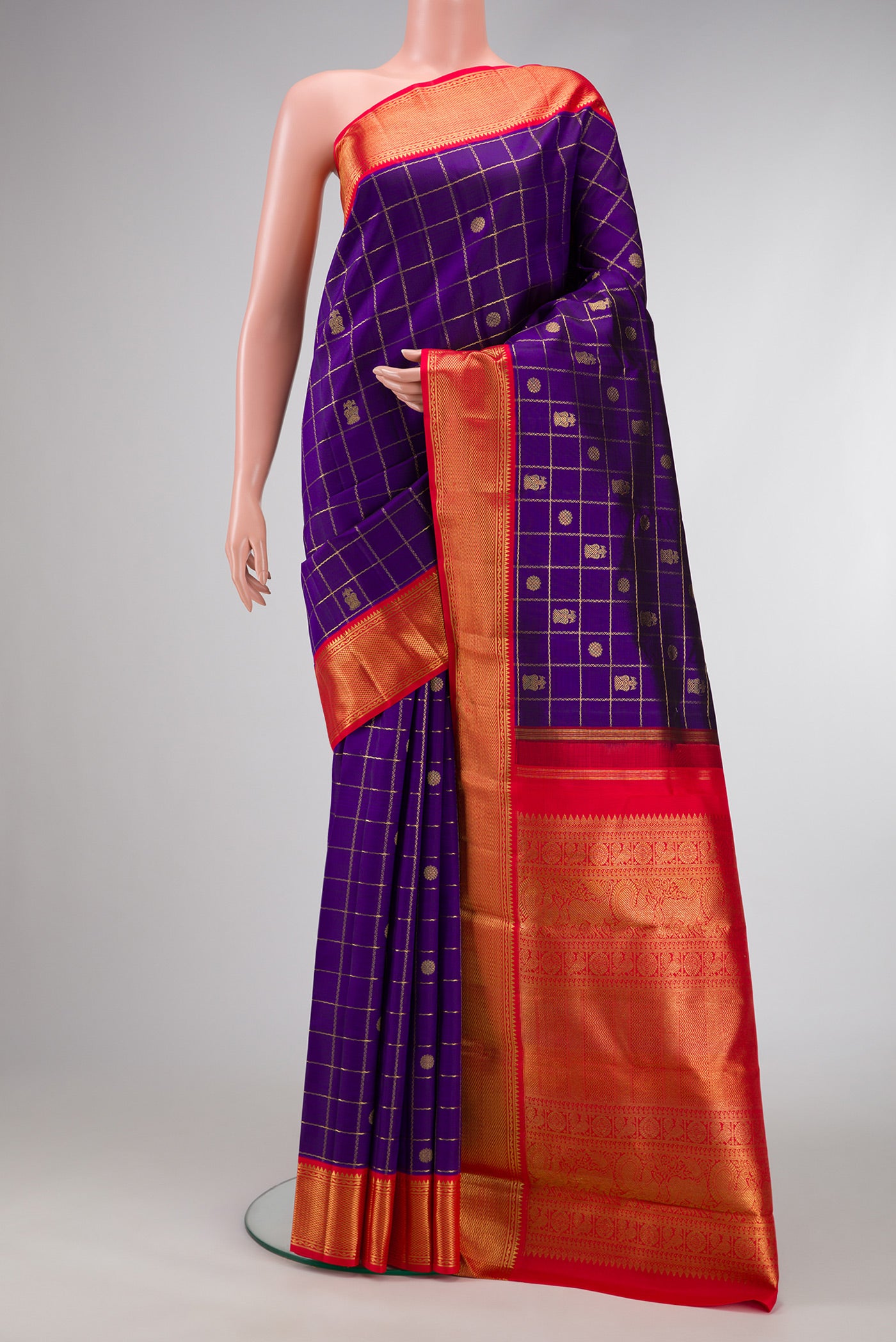 Pure Silk Pure Zari Violet Dual Tone Kanjivaram Saree with Checked design on the body and Zari Border.  displayed on a mannequin