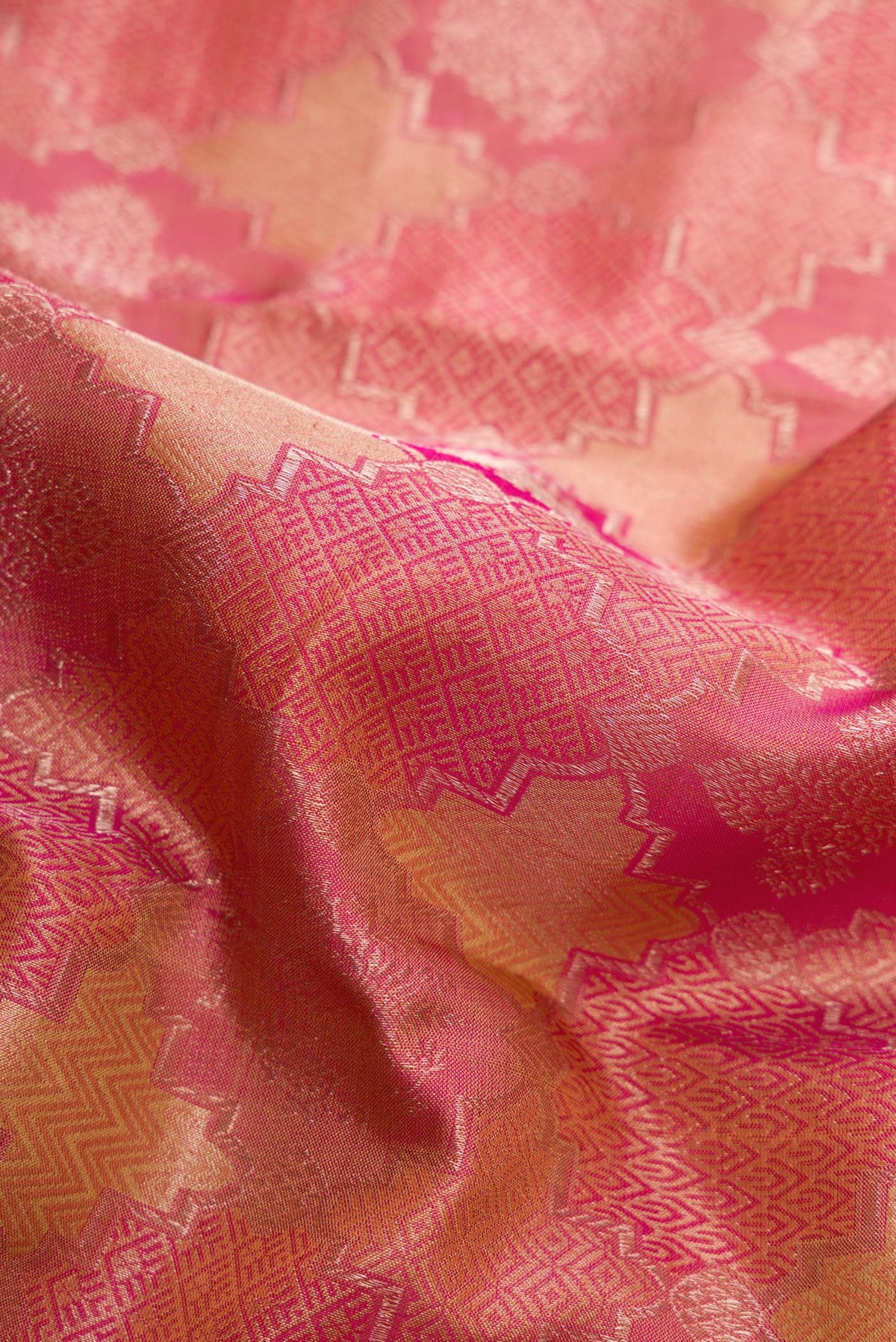 Close up of Dark Pink Dual Tone Kanjivaram Silk Saree with Jacquard With Zari Butta on the body and Zari Border.  displaying folds