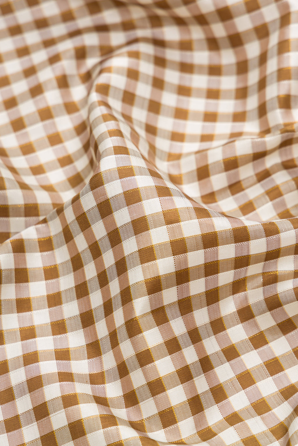 Close up of Pure Silk Pure Zari Beige Dual Tone Kanchipuram Saree with Checked design on the body and Ganga Jamuna Border.  displaying folds