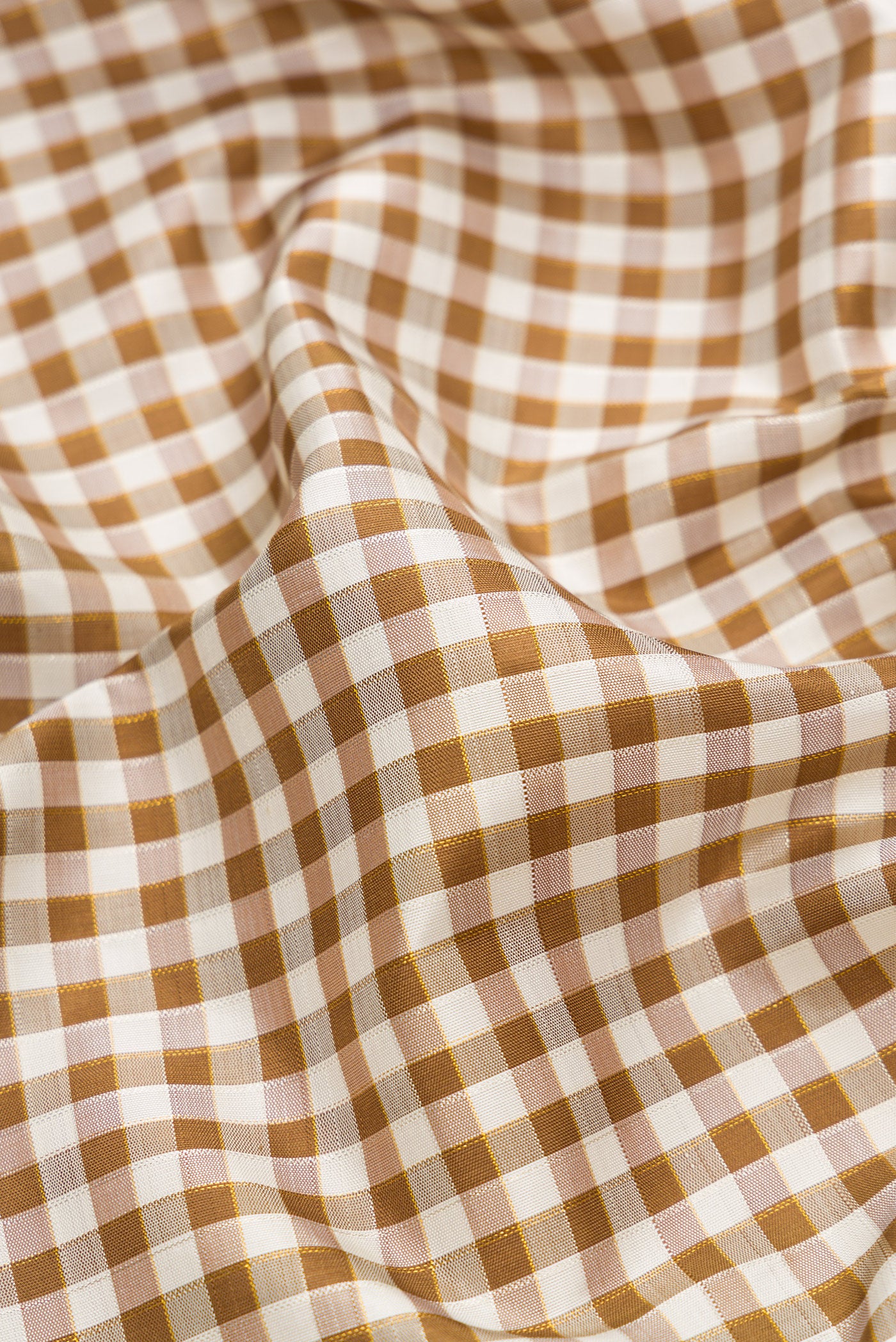 Close up of Pure Silk Pure Zari Beige Dual Tone Kanchipuram Saree with Checked design on the body and Ganga Jamuna Border.  displaying folds