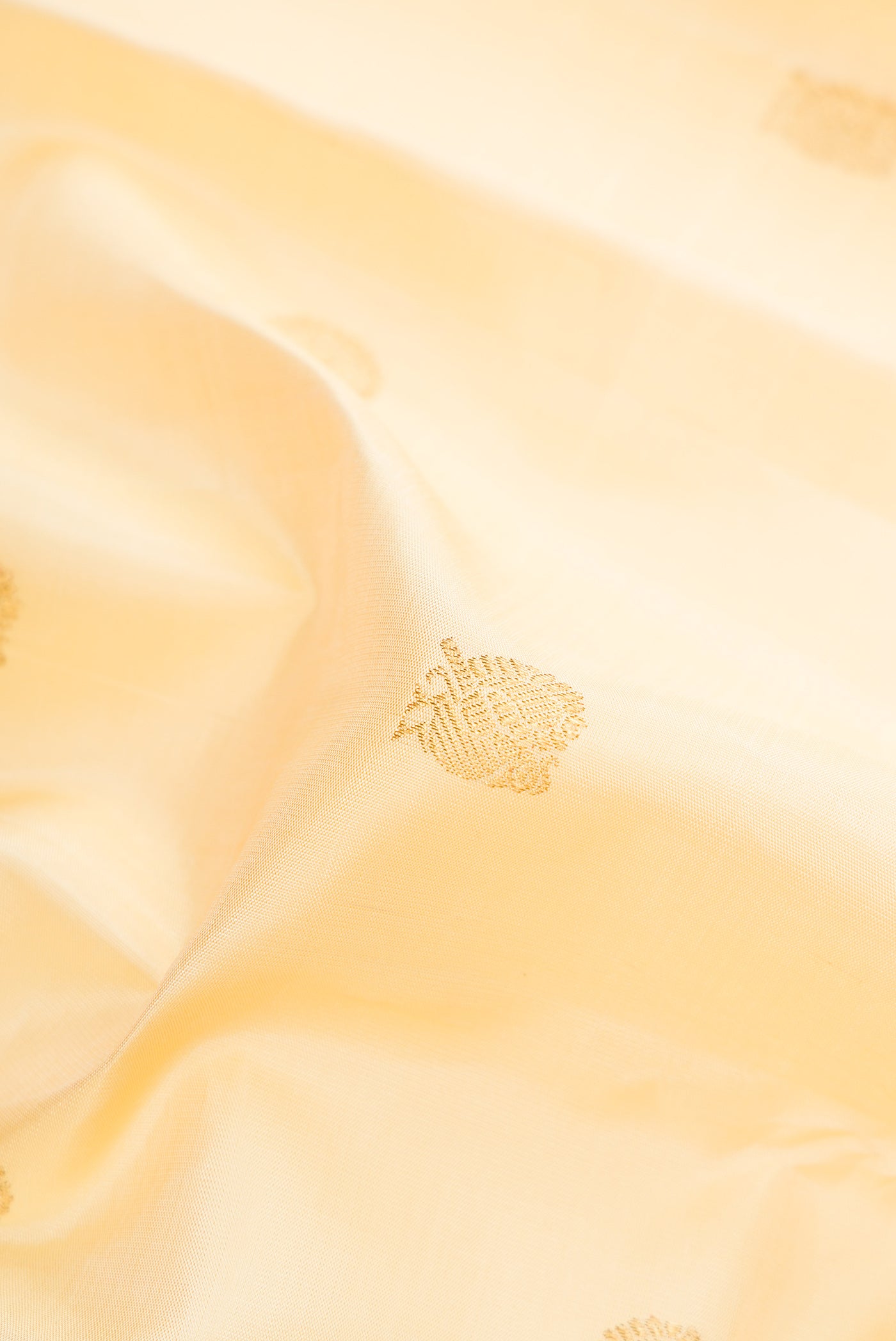 Close up of Pure Silk Pure Zari Sandal Dual Tone Kanjivaram Saree with Zari Butta on the body and Fancy Border.  displaying folds