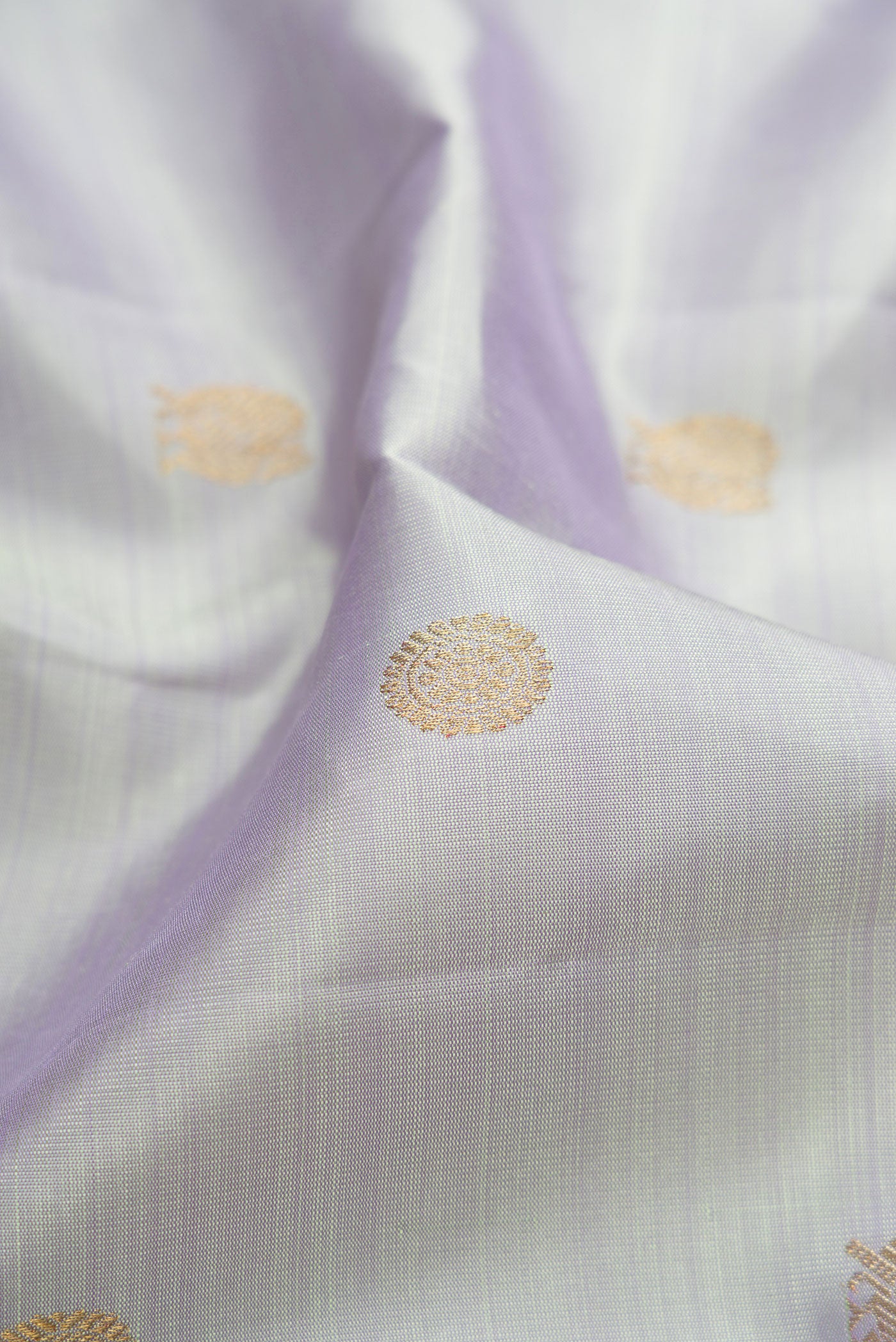 Close up of Pure Silk Pure Zari Light Blue Kanjivaram Saree with Zari Butta on the body and Zari Border.  displaying folds