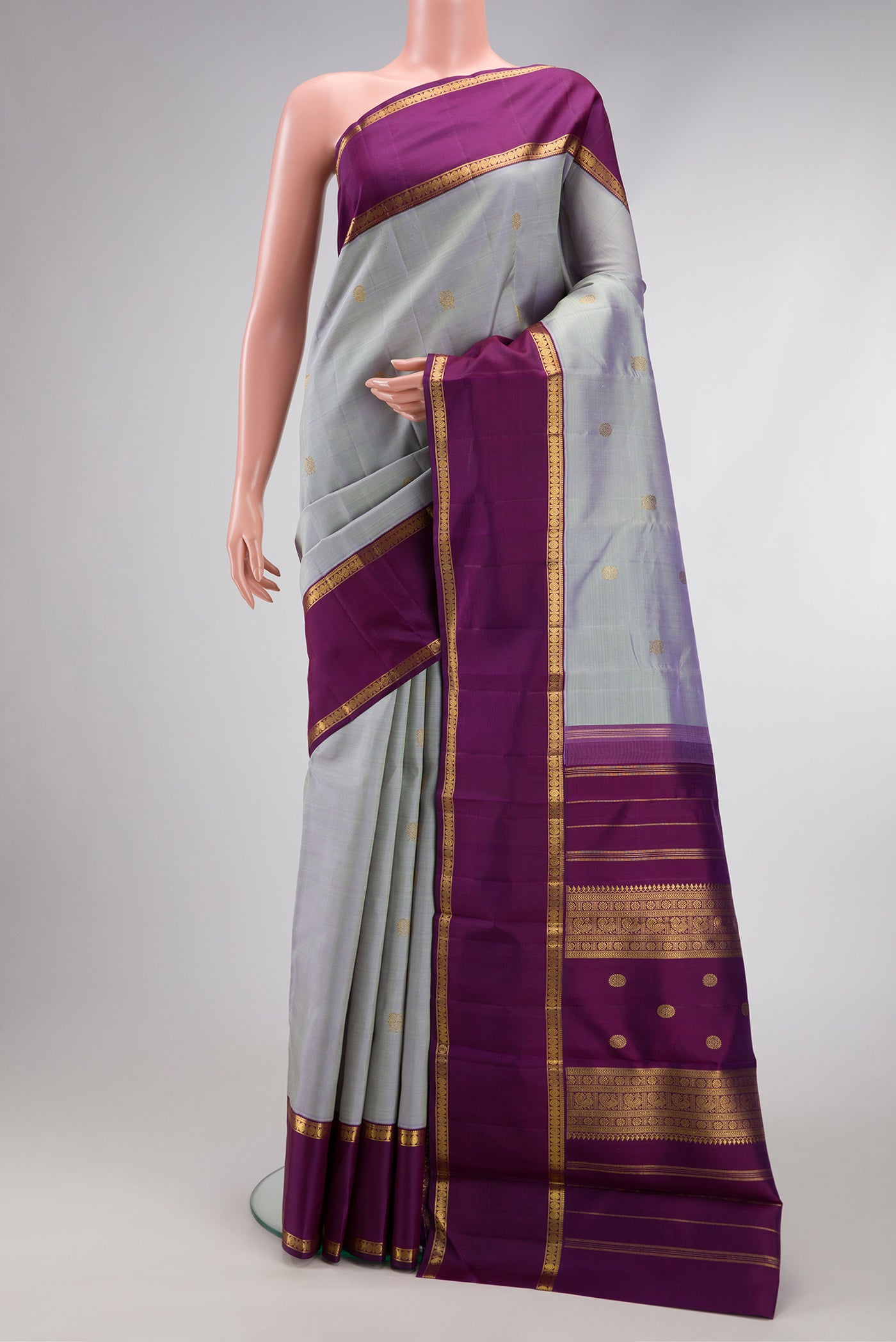 Pure Silk Pure Zari Light Blue Kanjivaram Saree with Zari Butta on the body and Zari Border.  displayed on a mannequin