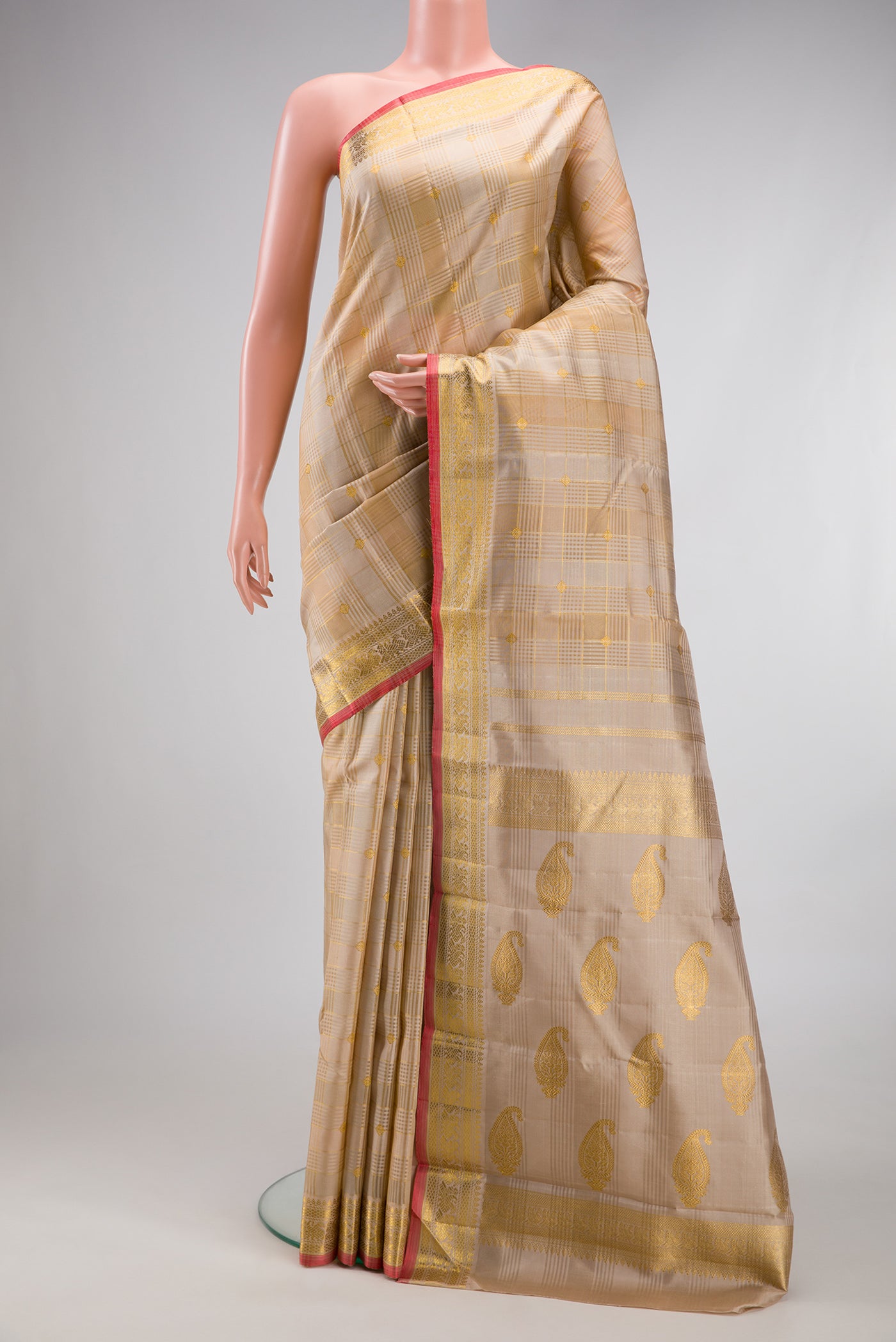 Pure Silk Pure Zari Beige Kanchipuram Saree with Checked design on the body and Zari Border.  displayed on a mannequin