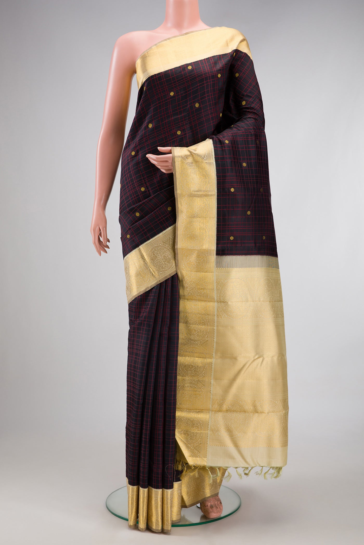 Pure Silk Pure Zari Black Kanchipuram Saree with Checked design on the body and Zari Border.  displayed on a mannequin