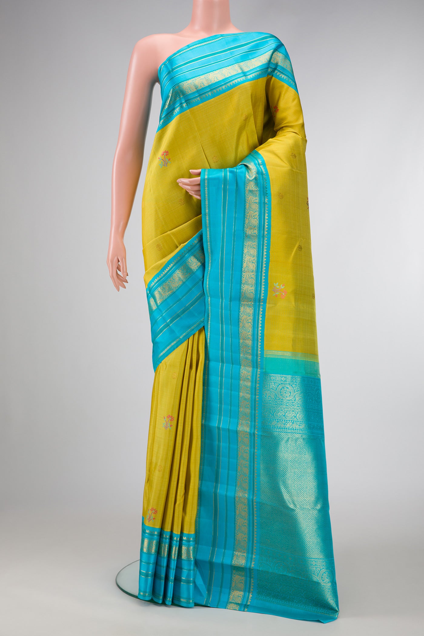Pure Silk Pure Zari Lemon Yellow Dual Tone Kanchipuram Saree with Zari And Thread Butta on the body and Zari And Thread Border.  displayed on a mannequin