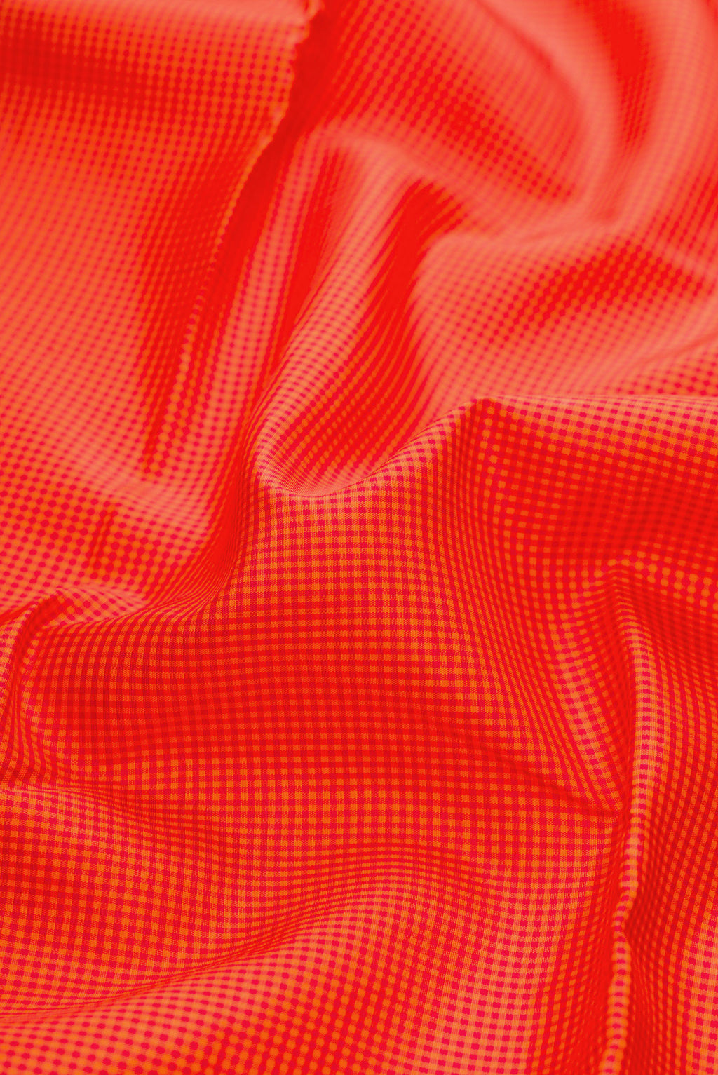 Close up of Pure Silk Pure Zari Orange Kanchipuram Saree with Checked design on the body and Without Border.  displaying folds