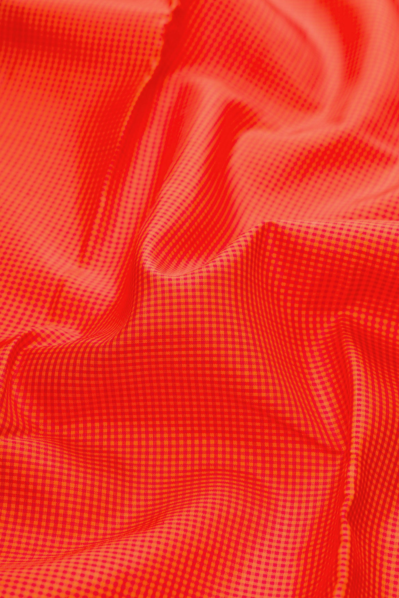Close up of Pure Silk Pure Zari Orange Kanchipuram Saree with Checked design on the body and Without Border.  displaying folds