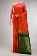 Pure Silk Pure Zari Orange Kanchipuram Saree with Checked design on the body and Without Border.  displayed on a mannequin