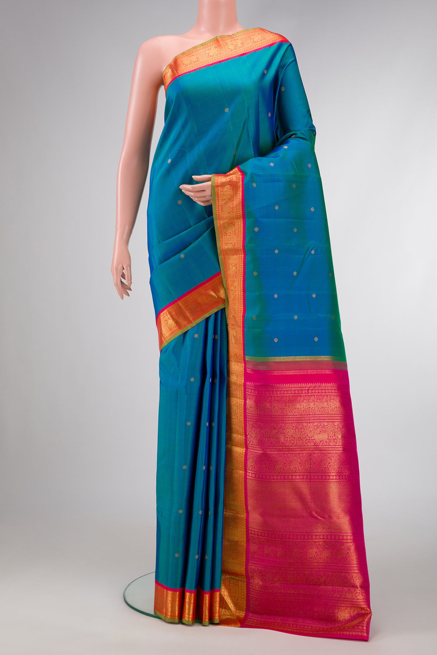 Pure Silk Pure Zari Peacock Blue Dual Tone Kanjivaram Saree with Zari Butta on the body and Zari Border.  displayed on a mannequin