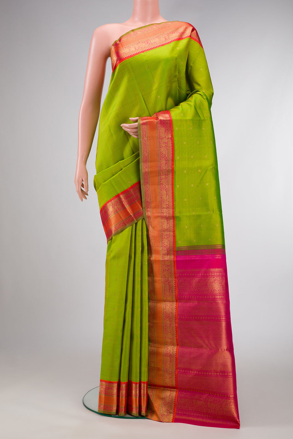 Pure Silk Pure Zari Parrot Green Dual Tone Kanjivaram Saree with Zari Butta on the body and Zari Border.  displayed on a mannequin