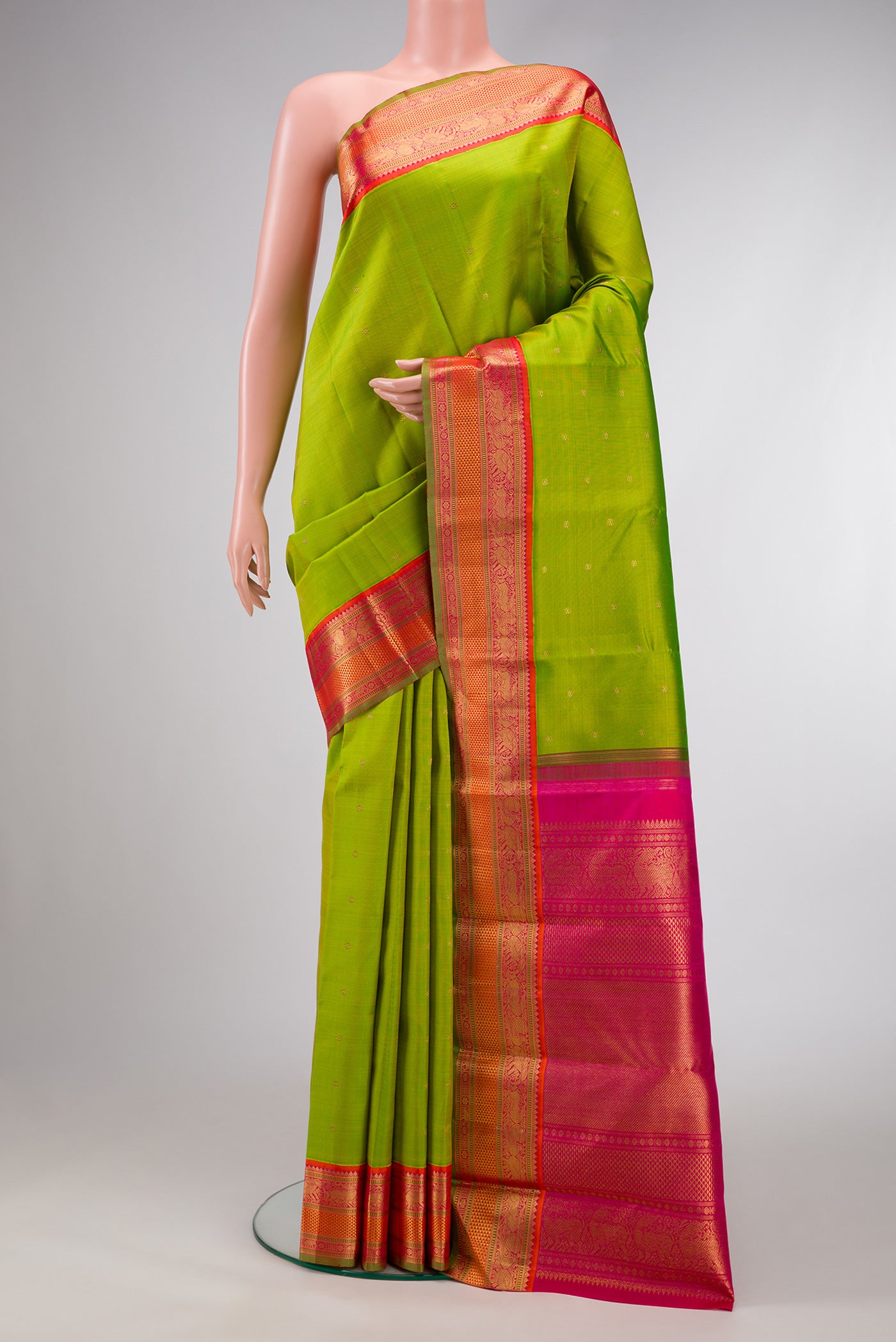 Pure Silk Pure Zari Parrot Green Dual Tone Kanjivaram Saree with Zari Butta on the body and Zari Border.  displayed on a mannequin