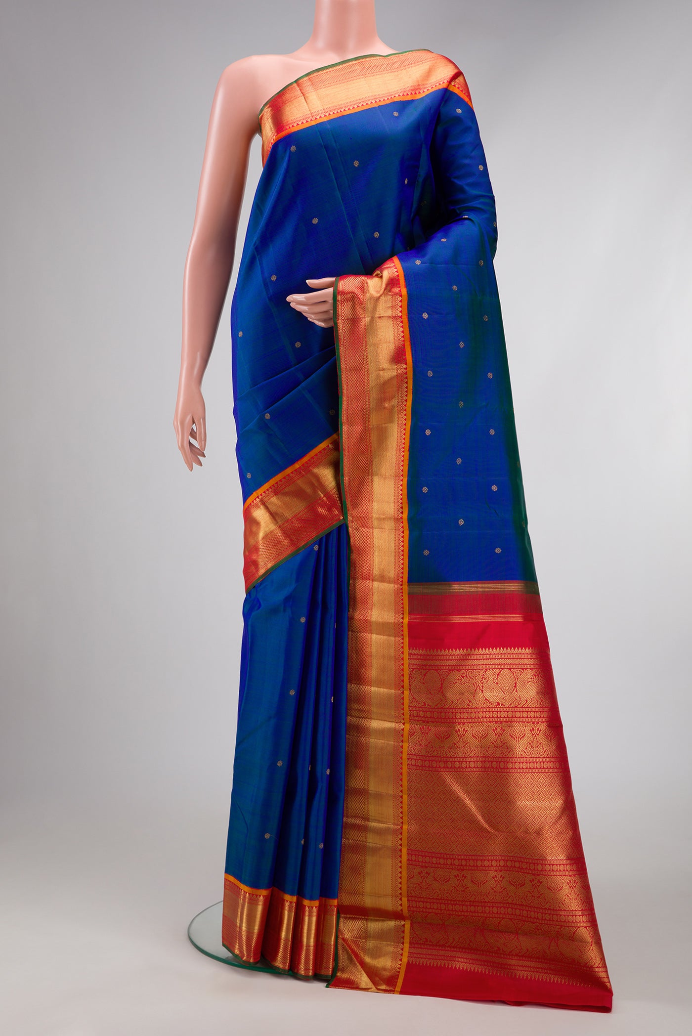 Pure Silk Pure Zari Peacock Blue Dual Tone Kanjivaram Saree with Zari Butta on the body and Zari Border.  displayed on a mannequin
