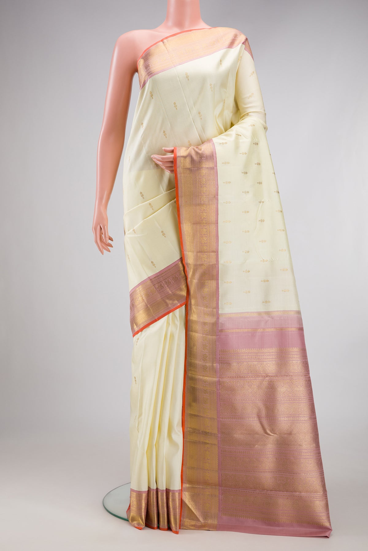 Pure Silk Pure Zari Off White Kanjivaram Saree with Zari Butta on the body and Zari Border.  displayed on a mannequin