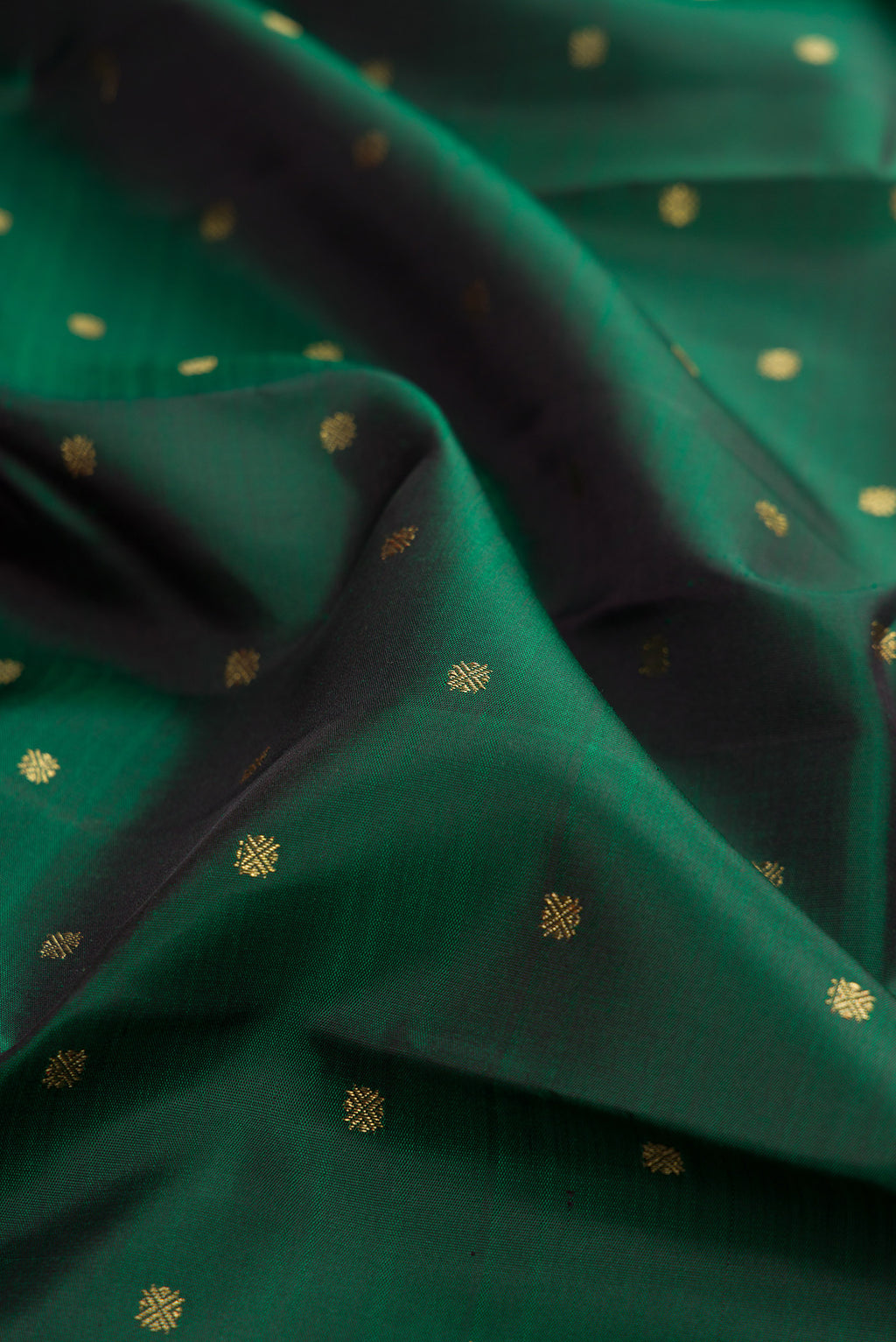 Close up of Pure Silk Pure Zari Bottle Green Kanjivaram Saree with Zari Butta on the body and Zari Border.  displaying folds