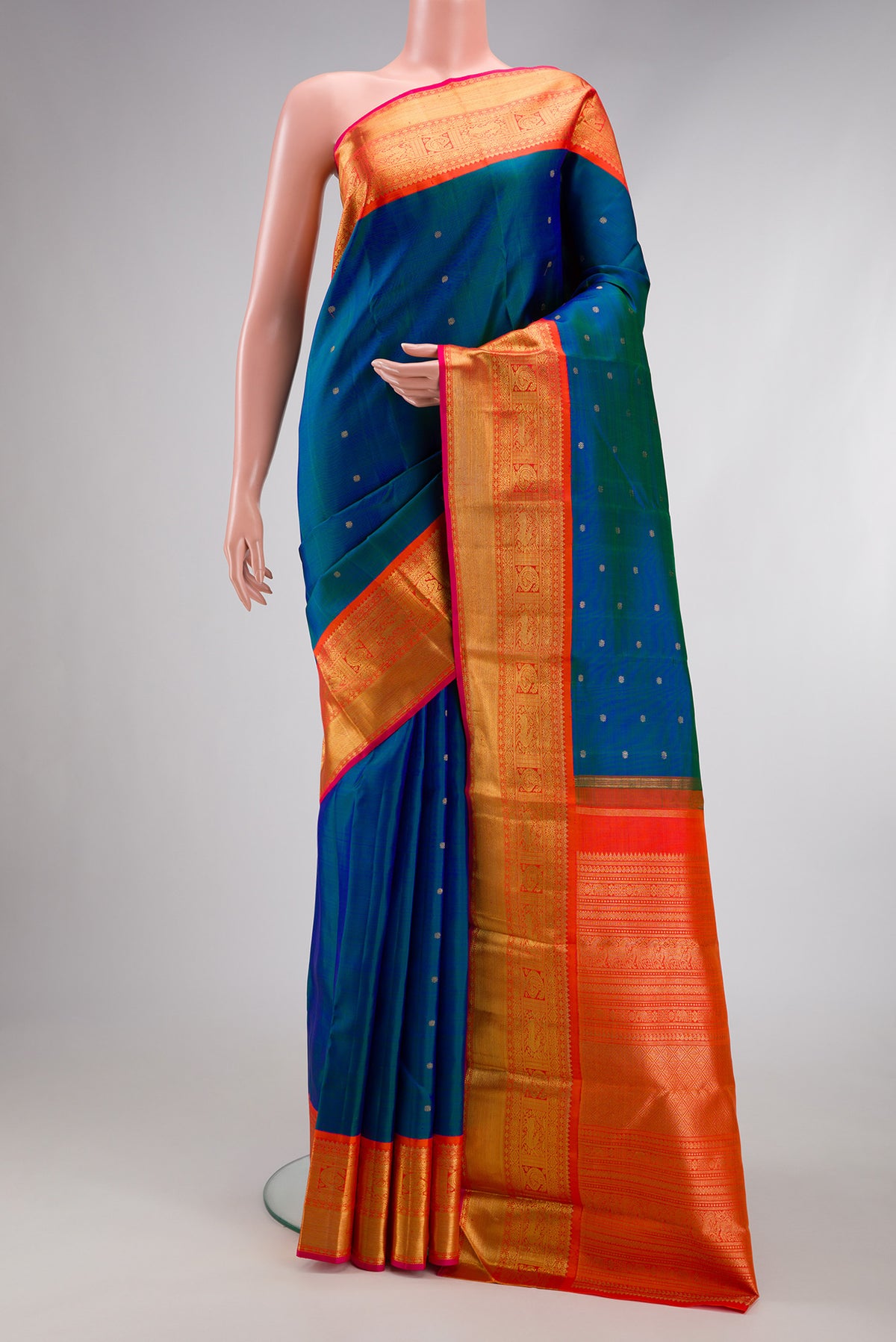 Pure Silk Pure Zari Peacock Blue Dual Tone Kanjivaram Saree with Zari Butta on the body and Zari Border.  displayed on a mannequin