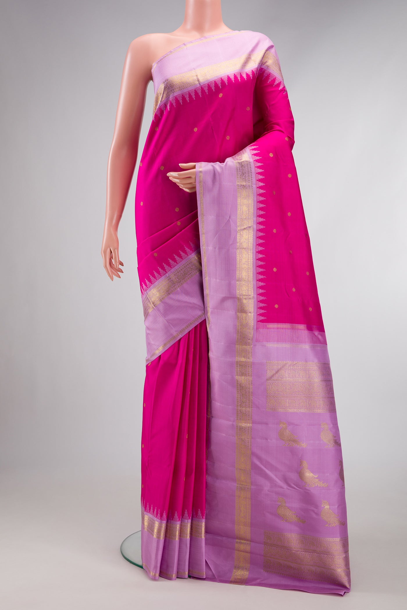 Pure Silk Pure Zari Dark Pink Kanjivaram Saree with Zari Butta on the body and Fancy Border.  displayed on a mannequin
