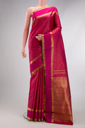 Pure Silk Pure Zari Rani Pink Kanjivaram Saree with Zari Butta on the body and Zari Border.  displayed on a mannequin