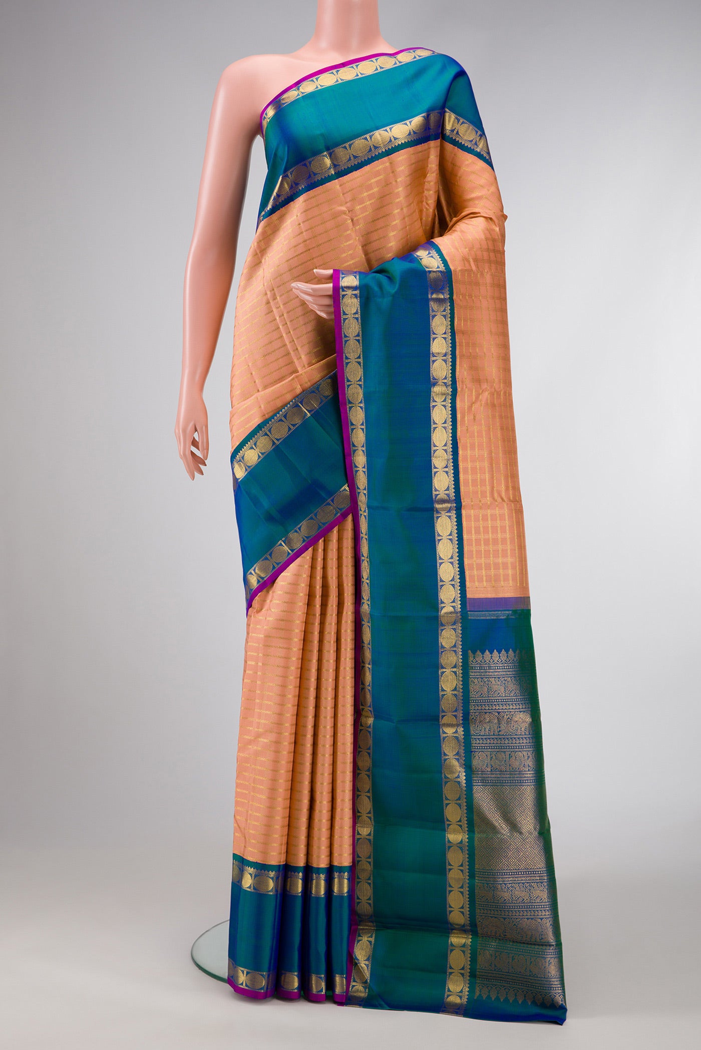Pure Silk Pure Zari Golden Peach Dual Tone Kanjivaram Saree with Checked design on the body and Zari Border.  displayed on a mannequin