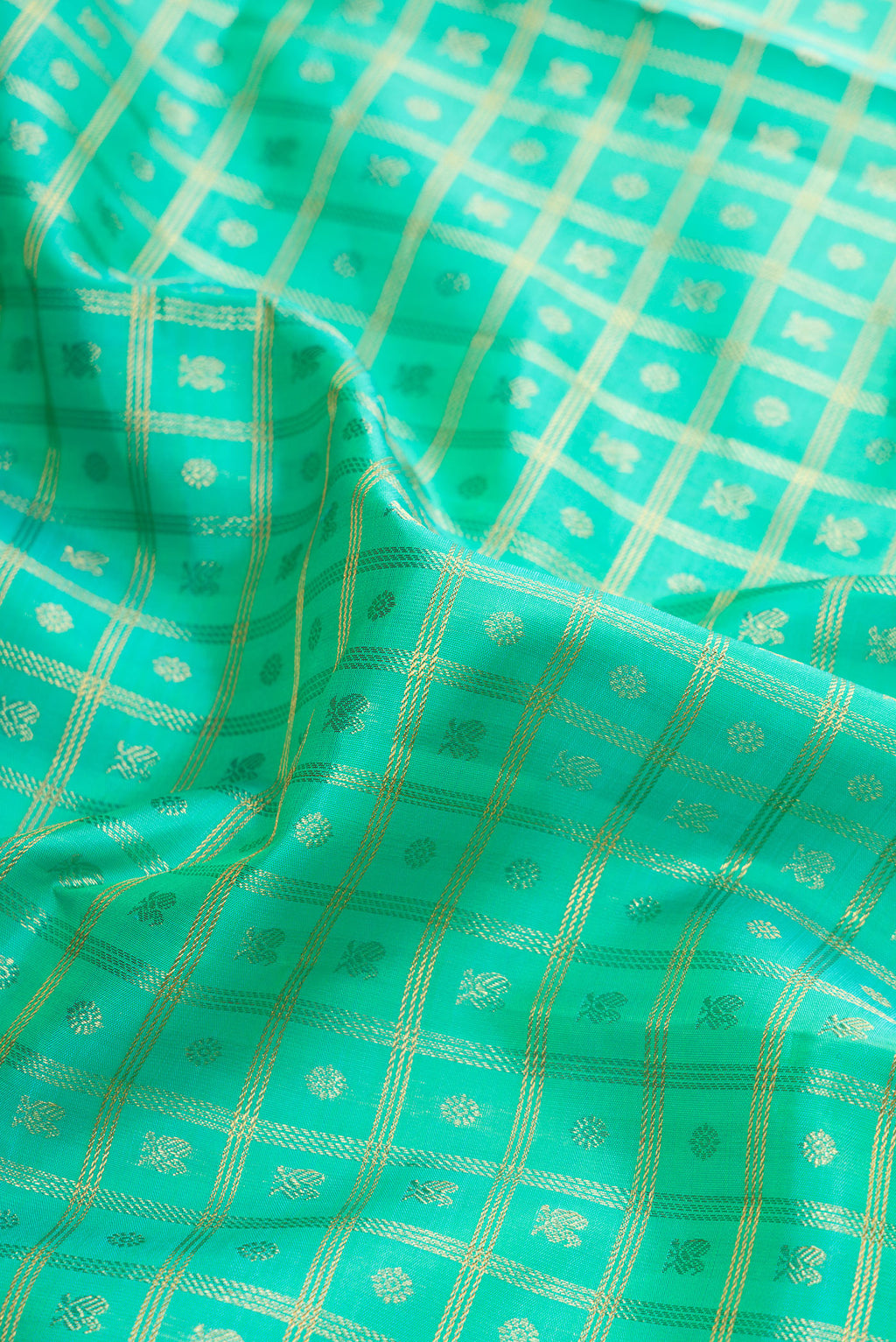 Close up of Pure Silk Pure Zari Sea Green Dual Tone Kanjivaram Saree with Zari Brocade on the body and Zari Border.  displaying folds