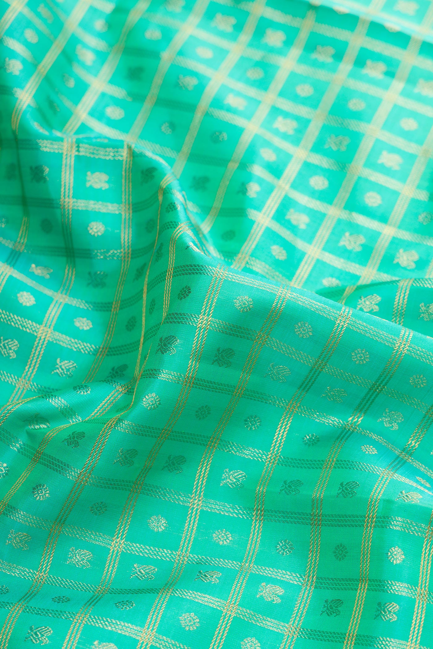 Close up of Pure Silk Pure Zari Sea Green Dual Tone Kanjivaram Saree with Zari Brocade on the body and Zari Border.  displaying folds