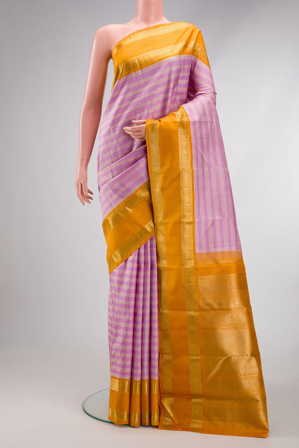 Pure Silk Pure Zari Lavender Kanjivaram Saree with Stripes on the body and Zari Border.  displayed on a mannequin