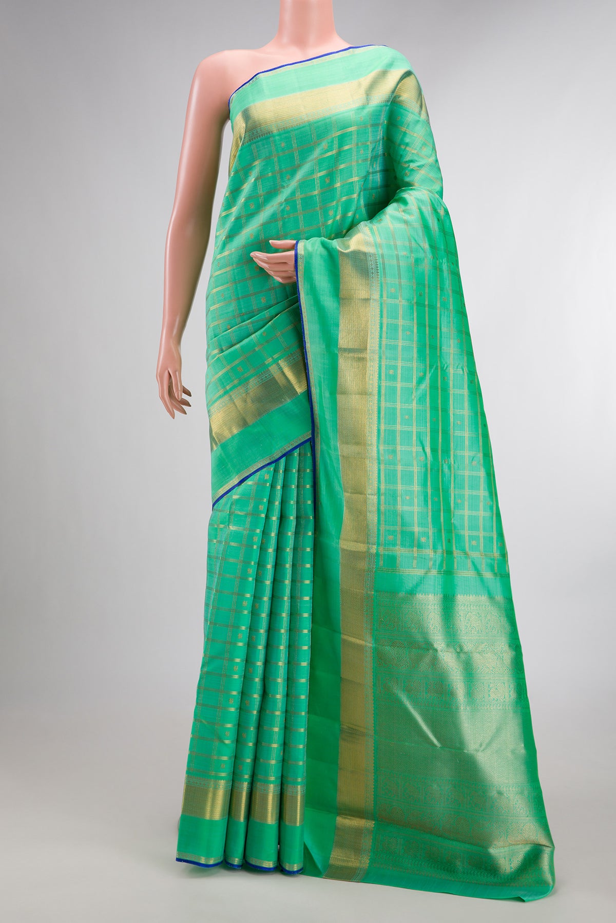 Pure Silk Pure Zari Sea Green Dual Tone Kanjivaram Saree with Checked design on the body and Zari Border.  displayed on a mannequin