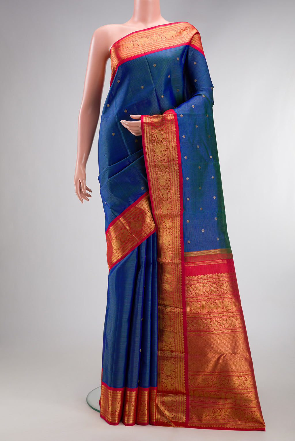 Pure Silk Pure Zari Peacock Blue Dual Tone Kanjivaram Saree with Zari Butta on the body and Zari Border.  displayed on a mannequin