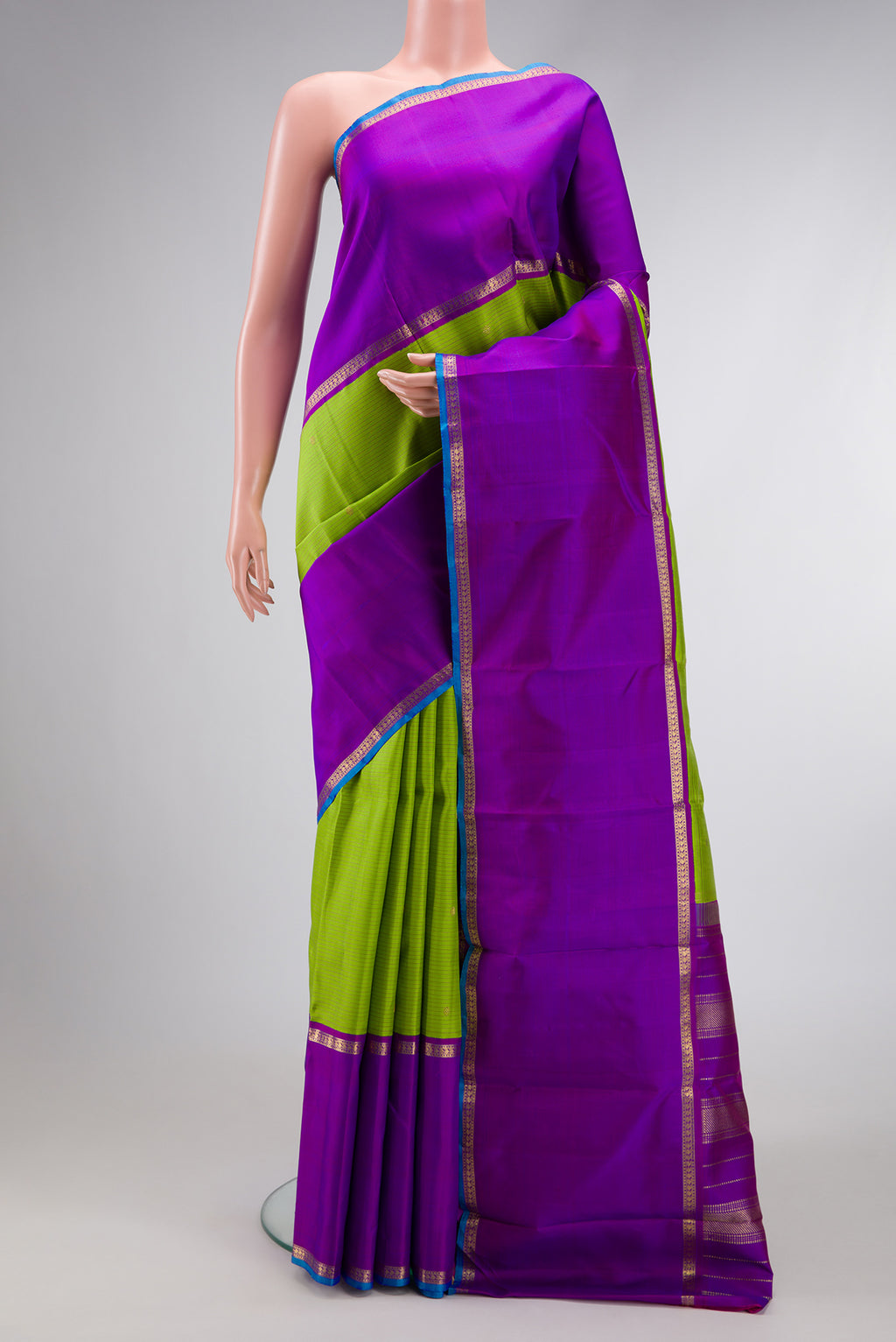 Pure Silk Pure Zari Parrot Green Dual Tone Kanchipuram Saree with Stripes on the body and Zari Border.  displayed on a mannequin