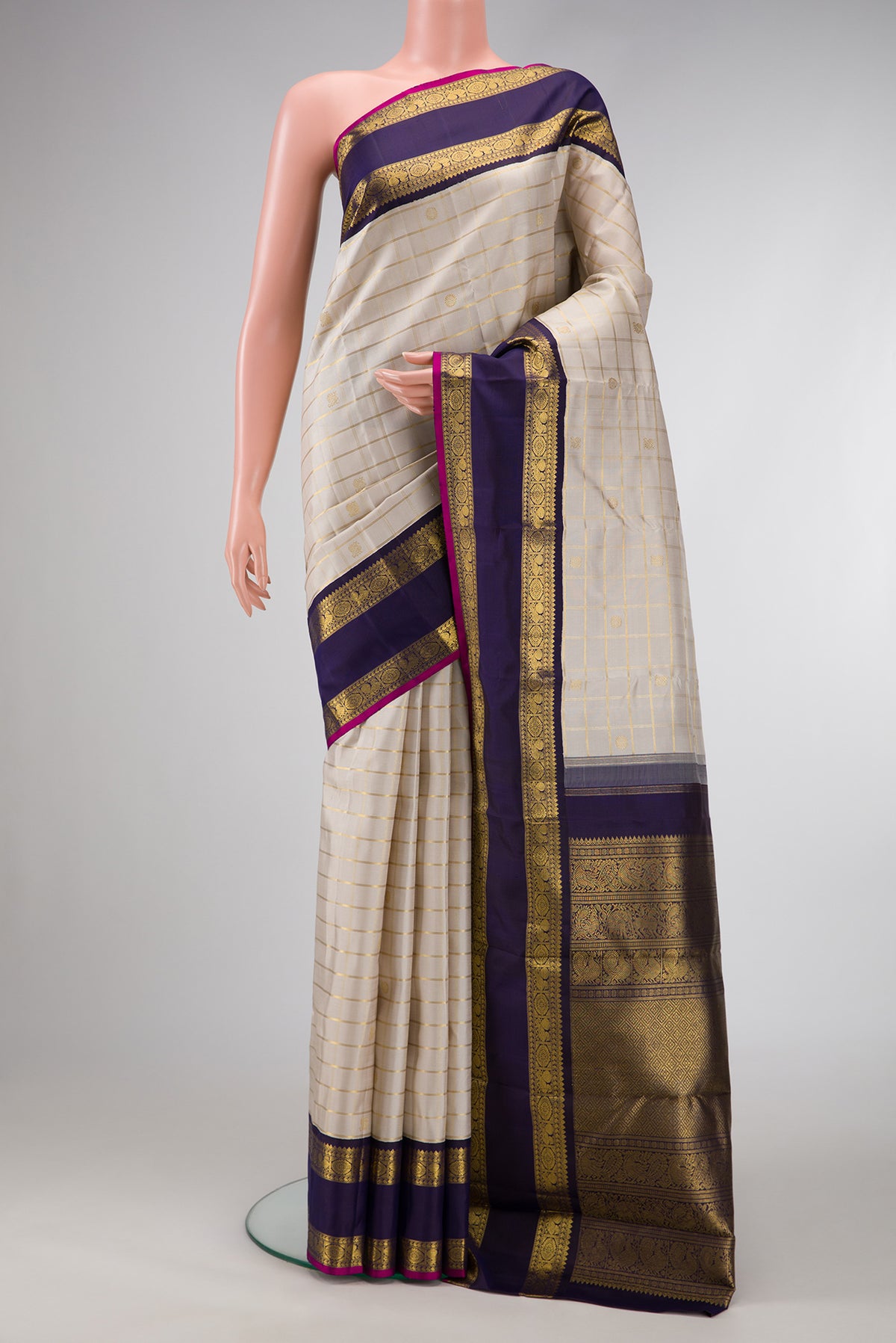 Pure Silk Pure Zari Off White Dual Tone Kanjivaram Saree with Checked design on the body and Zari Border.  displayed on a mannequin