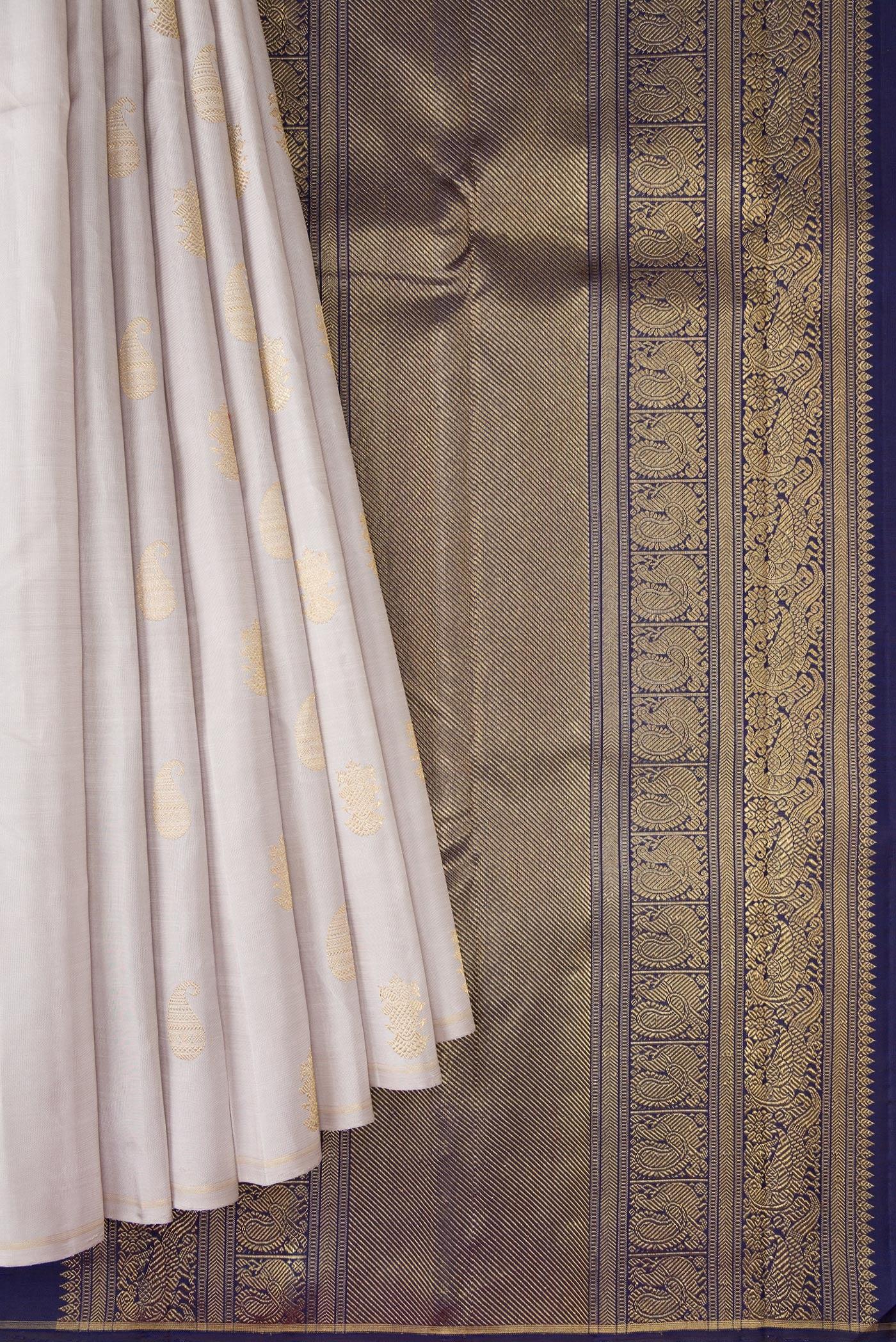 Pleats and pallu of Pure Silk Pure Zari Grey Kanchipuram Saree with Zari Butta on the body and Thin Zari Line. 
