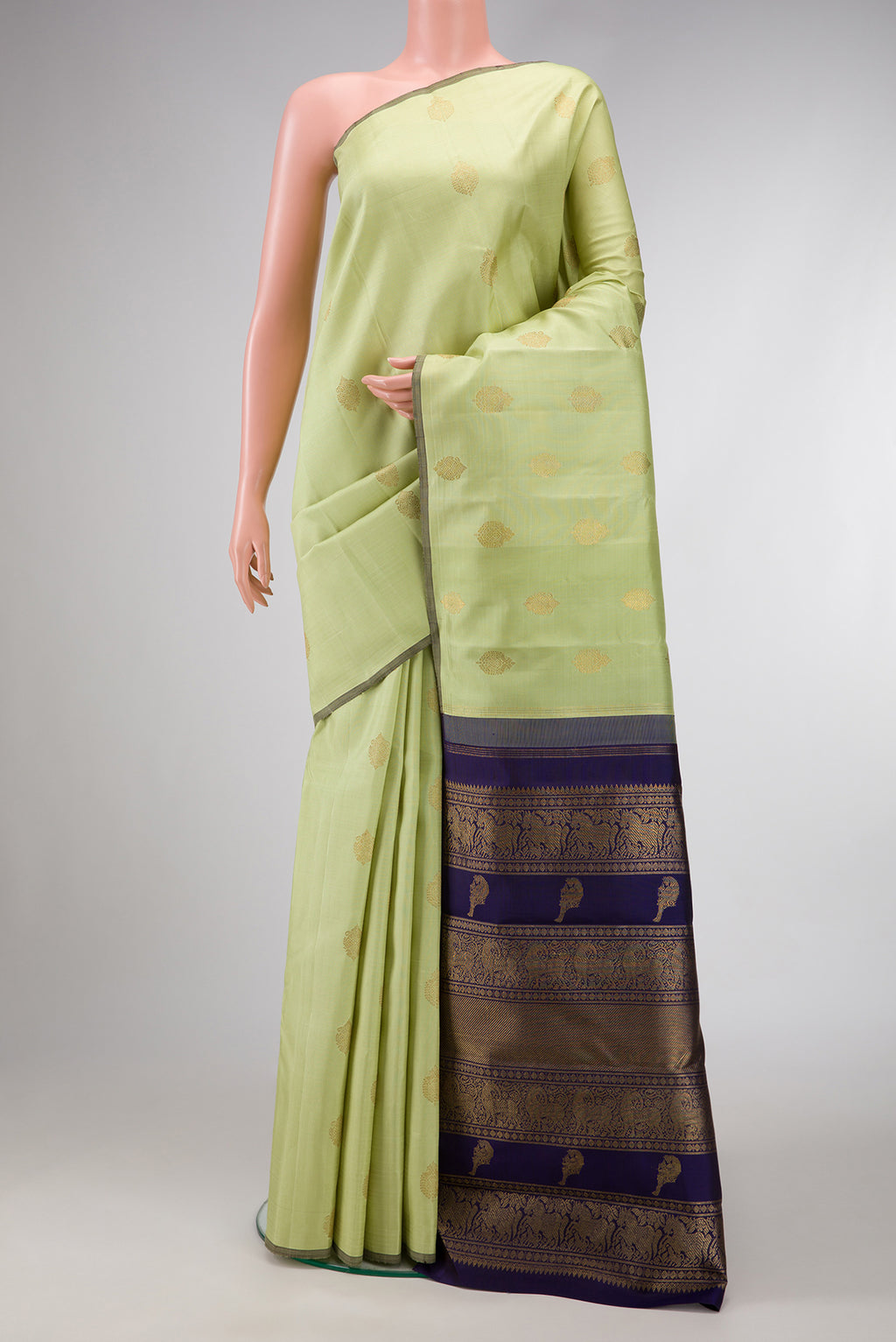Pure Silk Pure Zari Pista Green Dual Tone Kanchipuram Saree with Zari Butta on the body and Without Border.  displayed on a mannequin